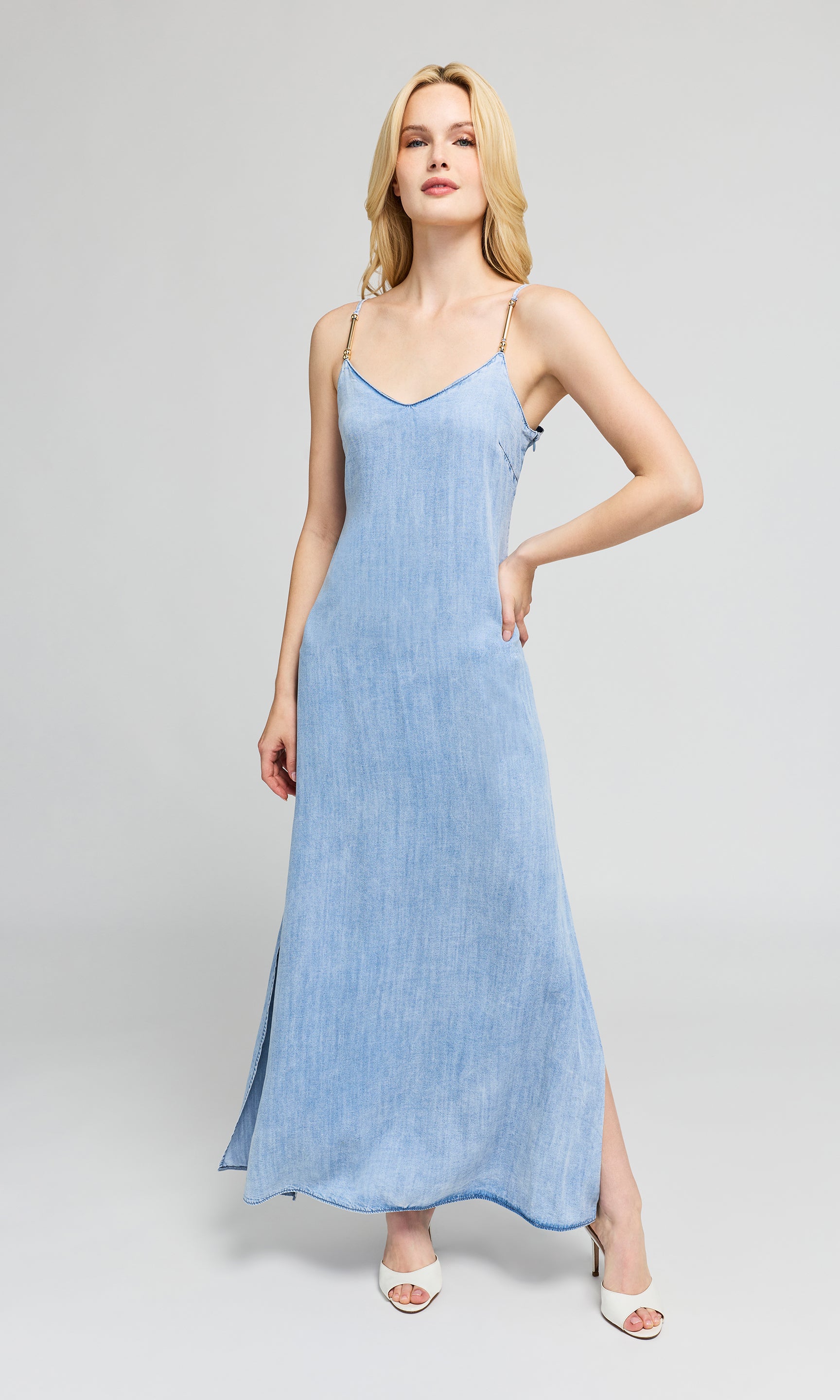 Woman wearing a light blue dress on a gray background