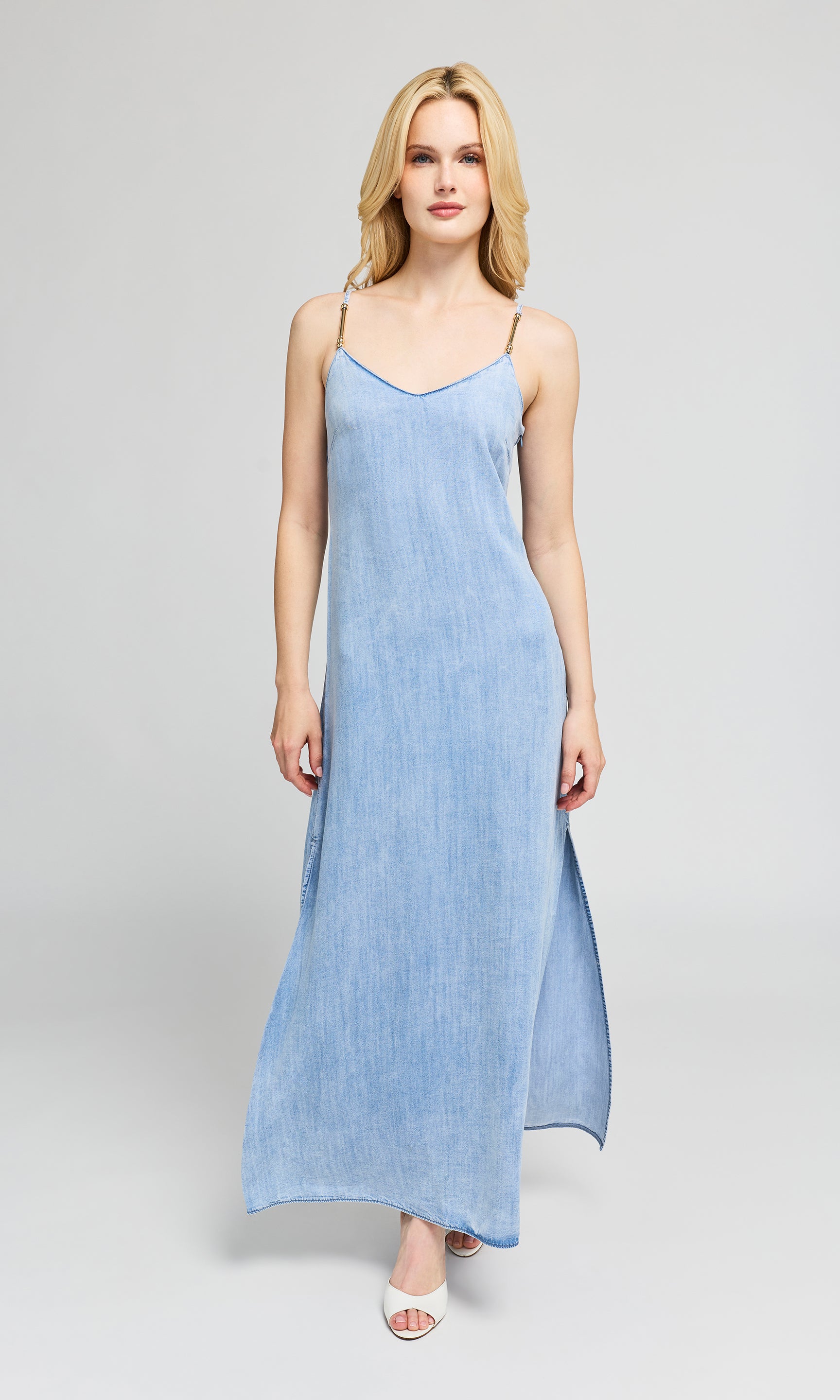 Woman wearing a light blue dress on a gray background