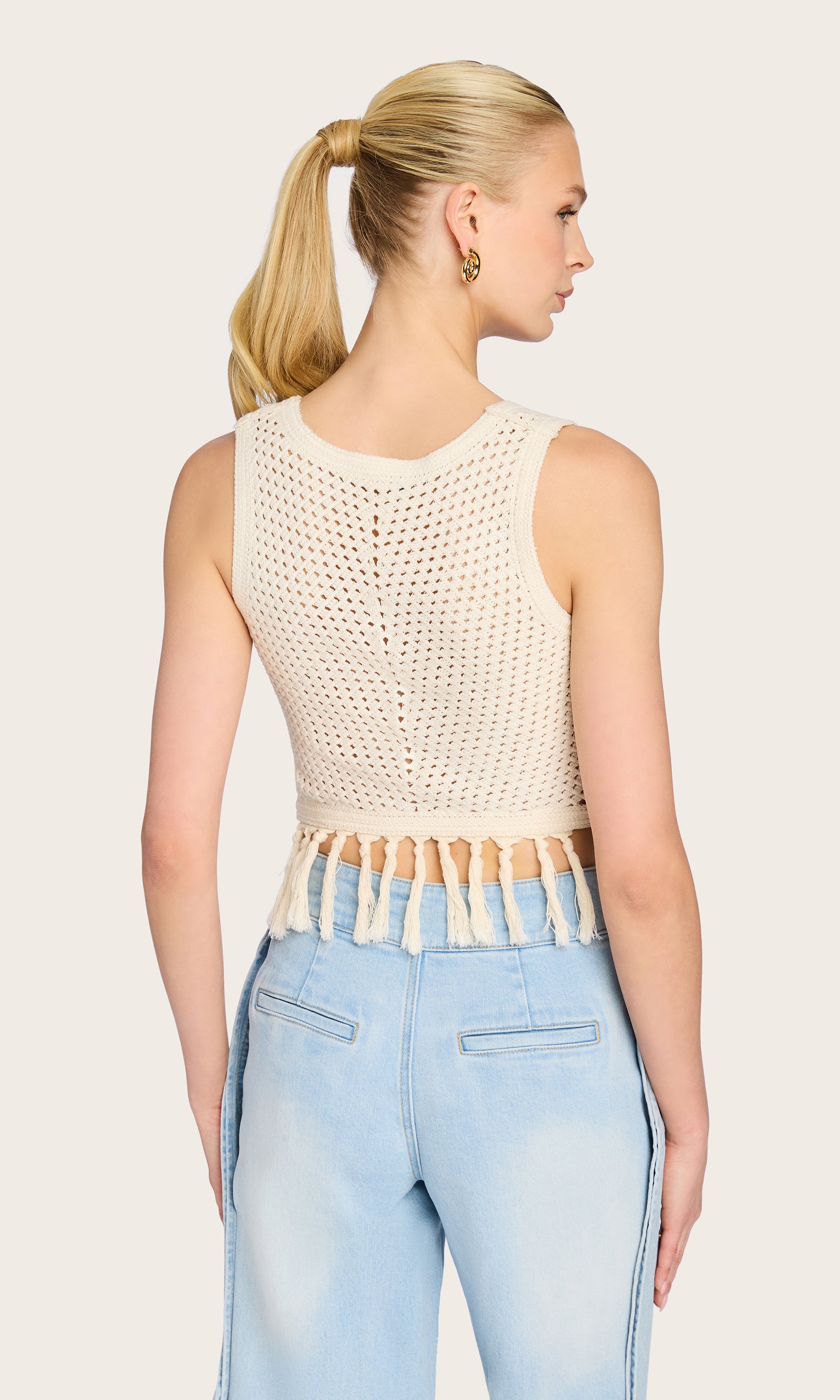 Rear view of the model in the Ginger Crochet Tank, emphasizing the open crochet weave and relaxed cropped fit from behind.