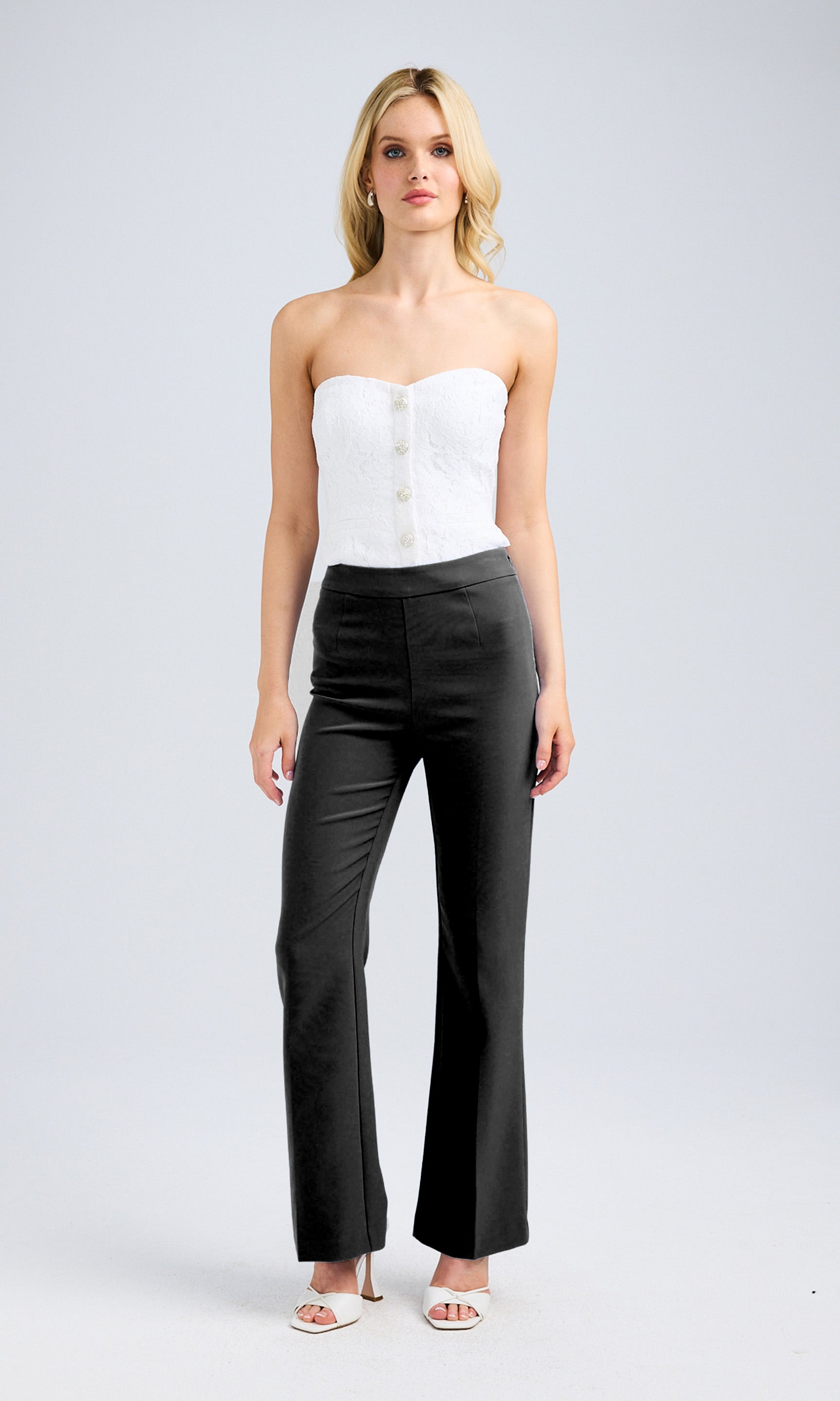 Full body view of the white lace vestier showcasing crystal buttons down the front.
