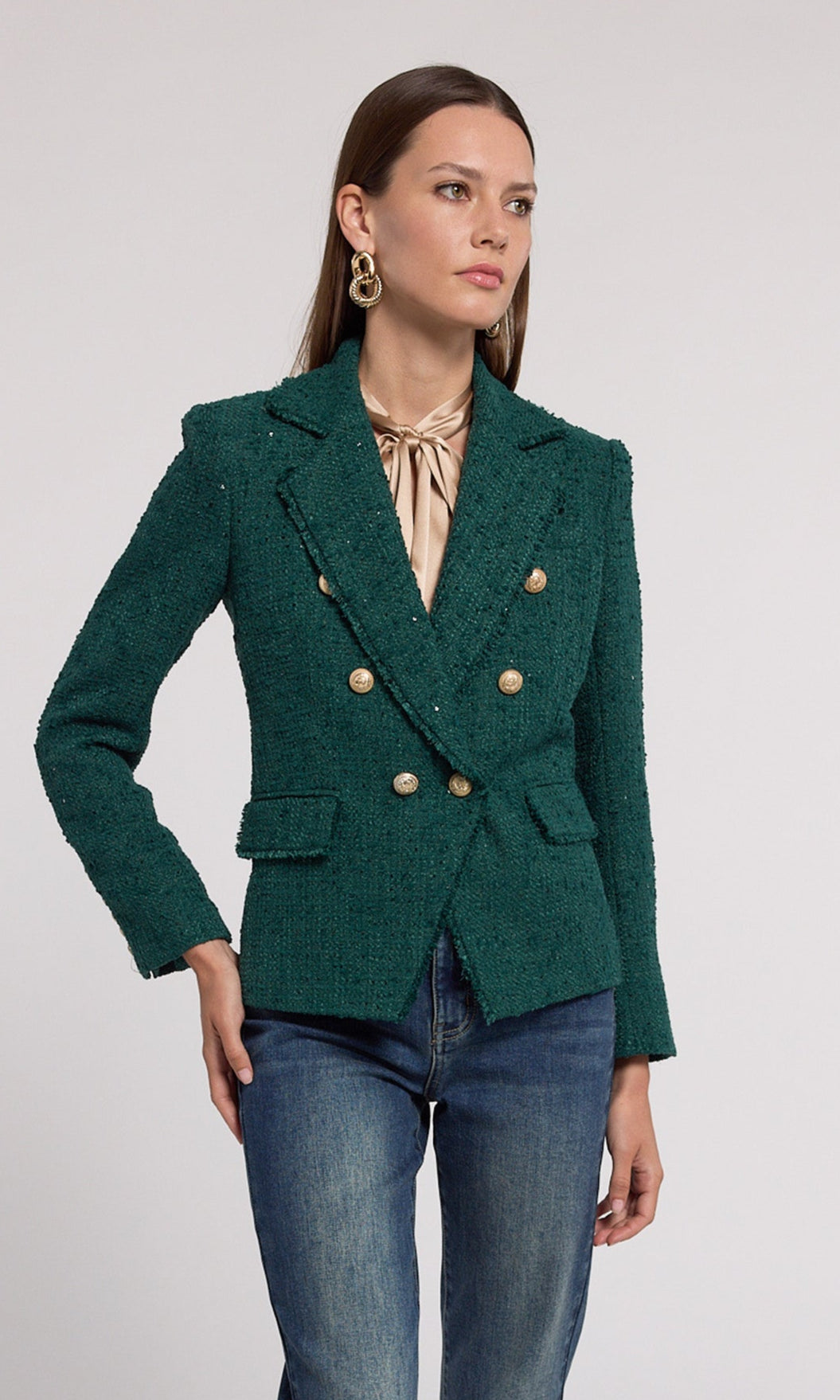 A green tweed blazer, featuring elegant gold buttons for a sophisticated touch.