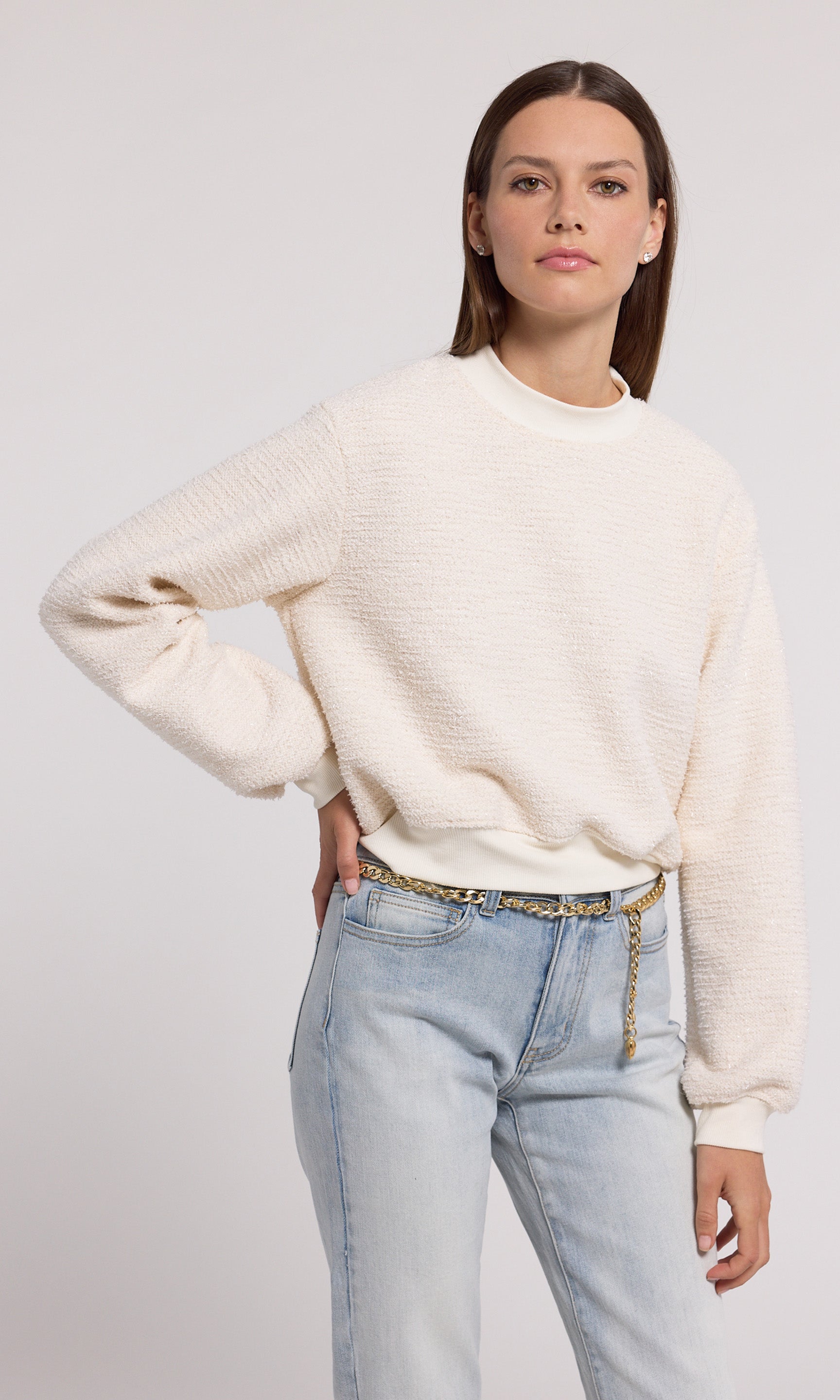 A cream sweatshirt crafted from soft knit fabric, showcasing a comfortable and stylish design suitable for various occasions.