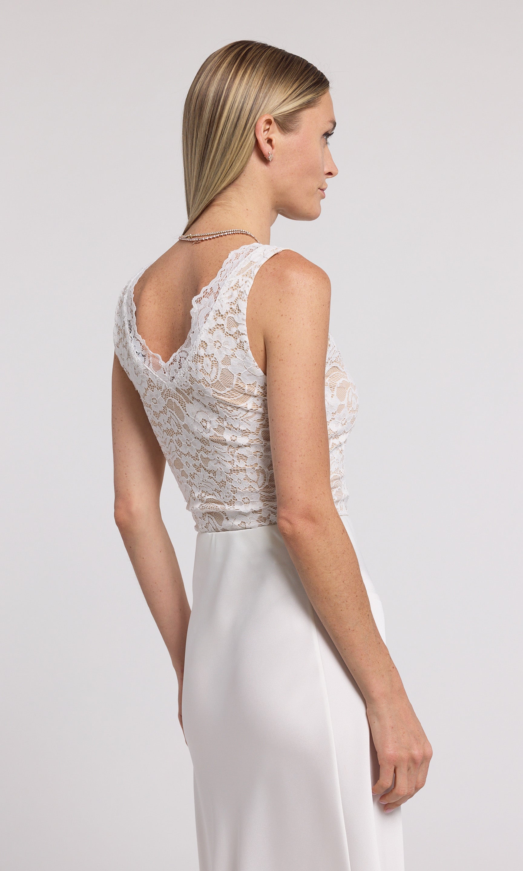 Beautiful white lace bodysuit showcasing a soft, textured fabric and a flattering shape for a chic appearance.