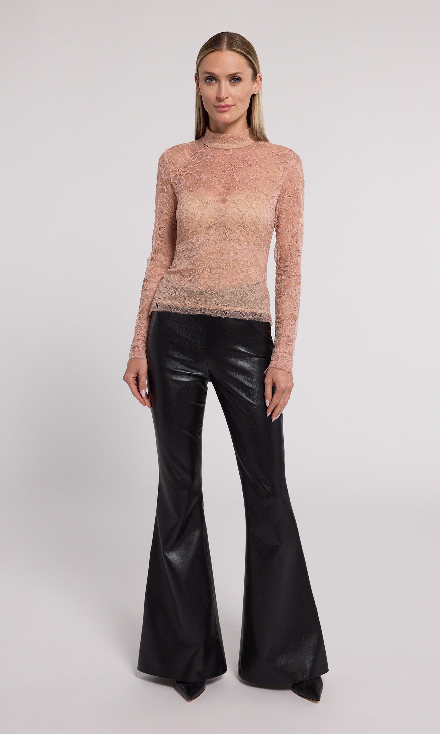 A long-sleeved blush lace top featuring a high neck, showcasing intricate lace patterns and elegant design.