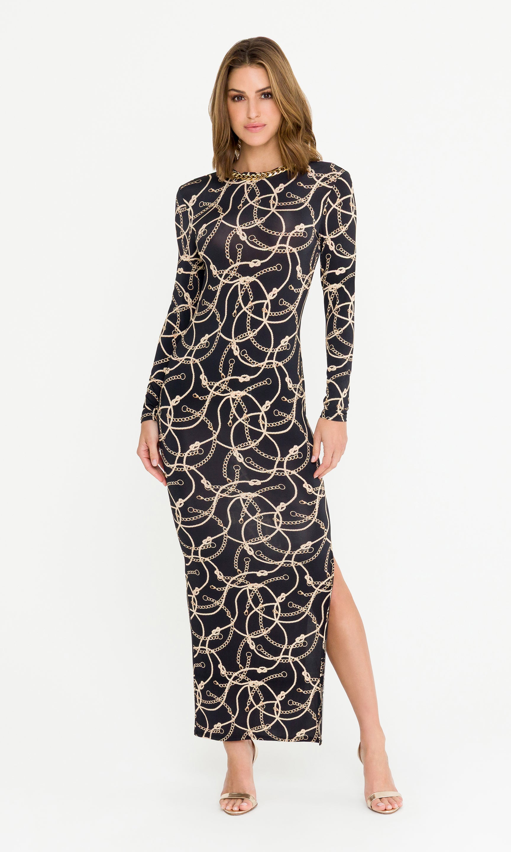Woman wearing a black dress with gold chain pattern on a white background
