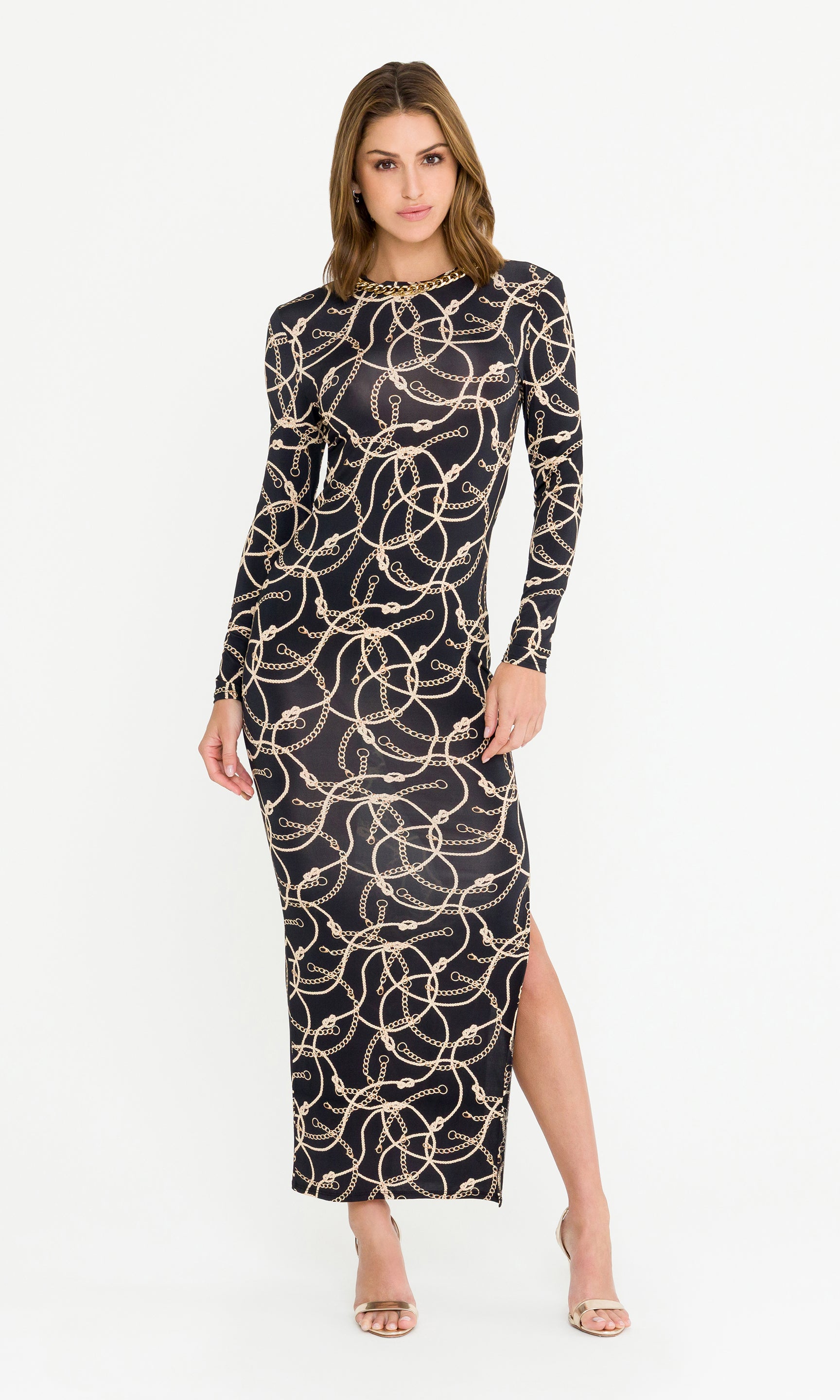 Woman wearing a black dress with gold chain patterns on a white background