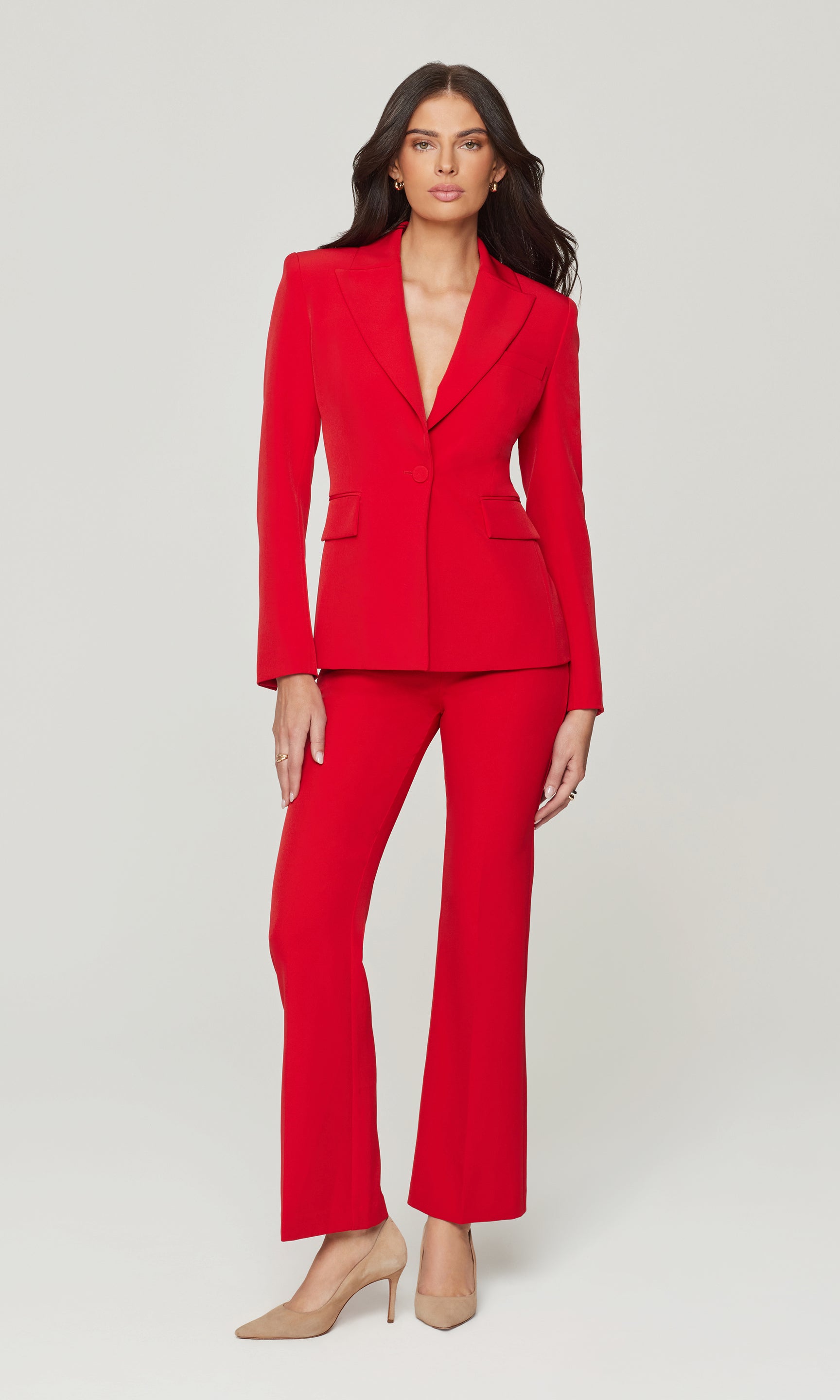 Woman wearing a red suit on a white background