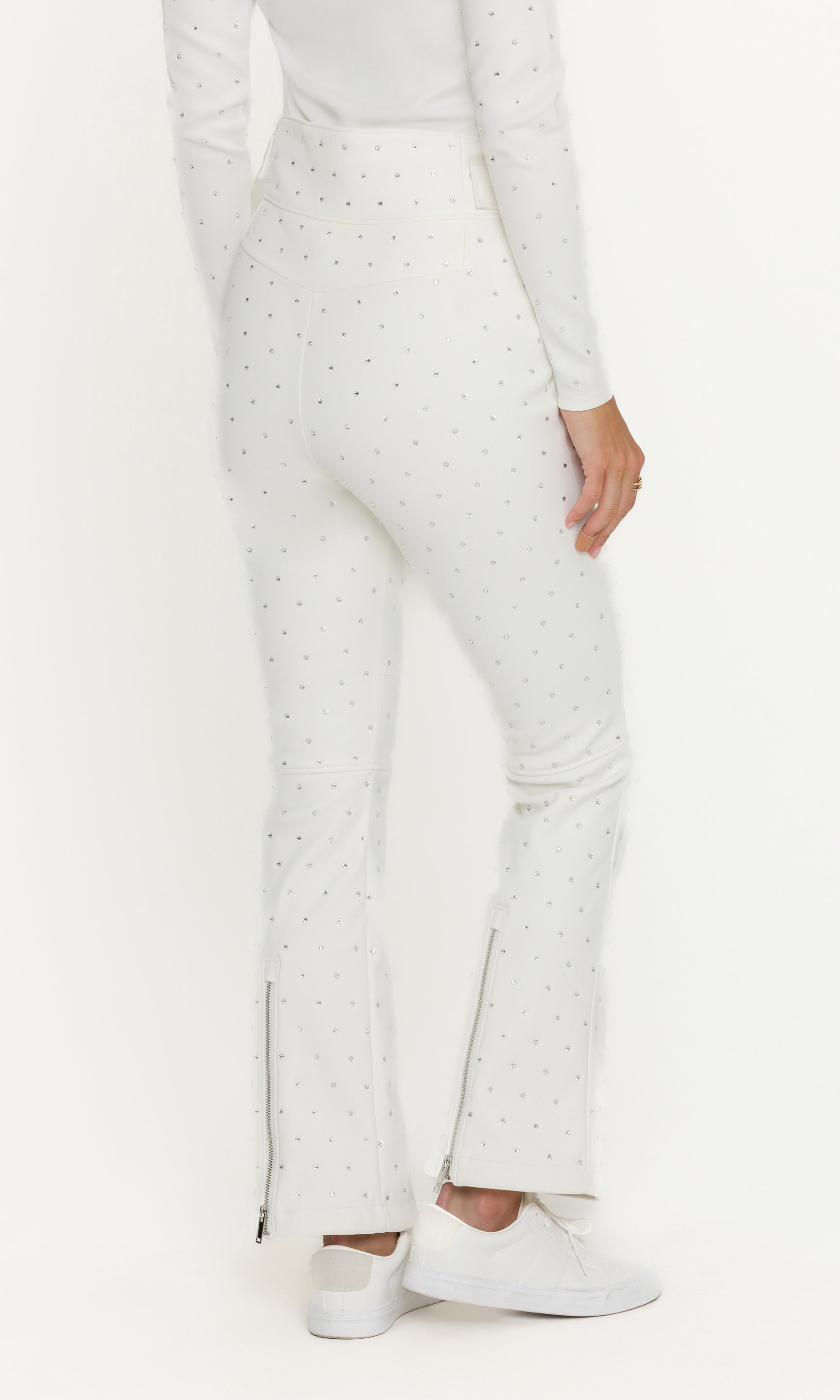 White pants with a subtle pattern worn by a person on a white background