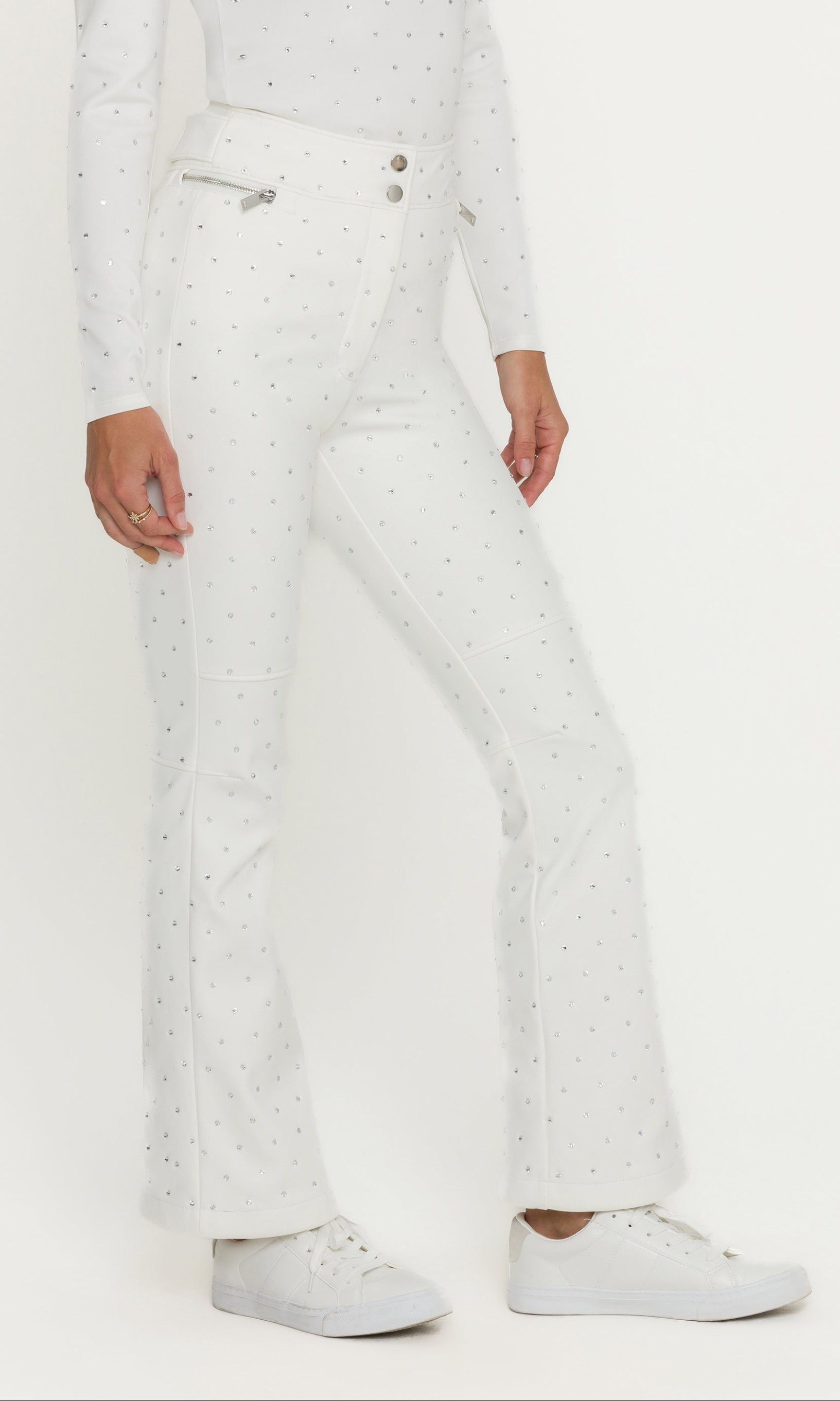 Person wearing a white snowsuit with a plain background