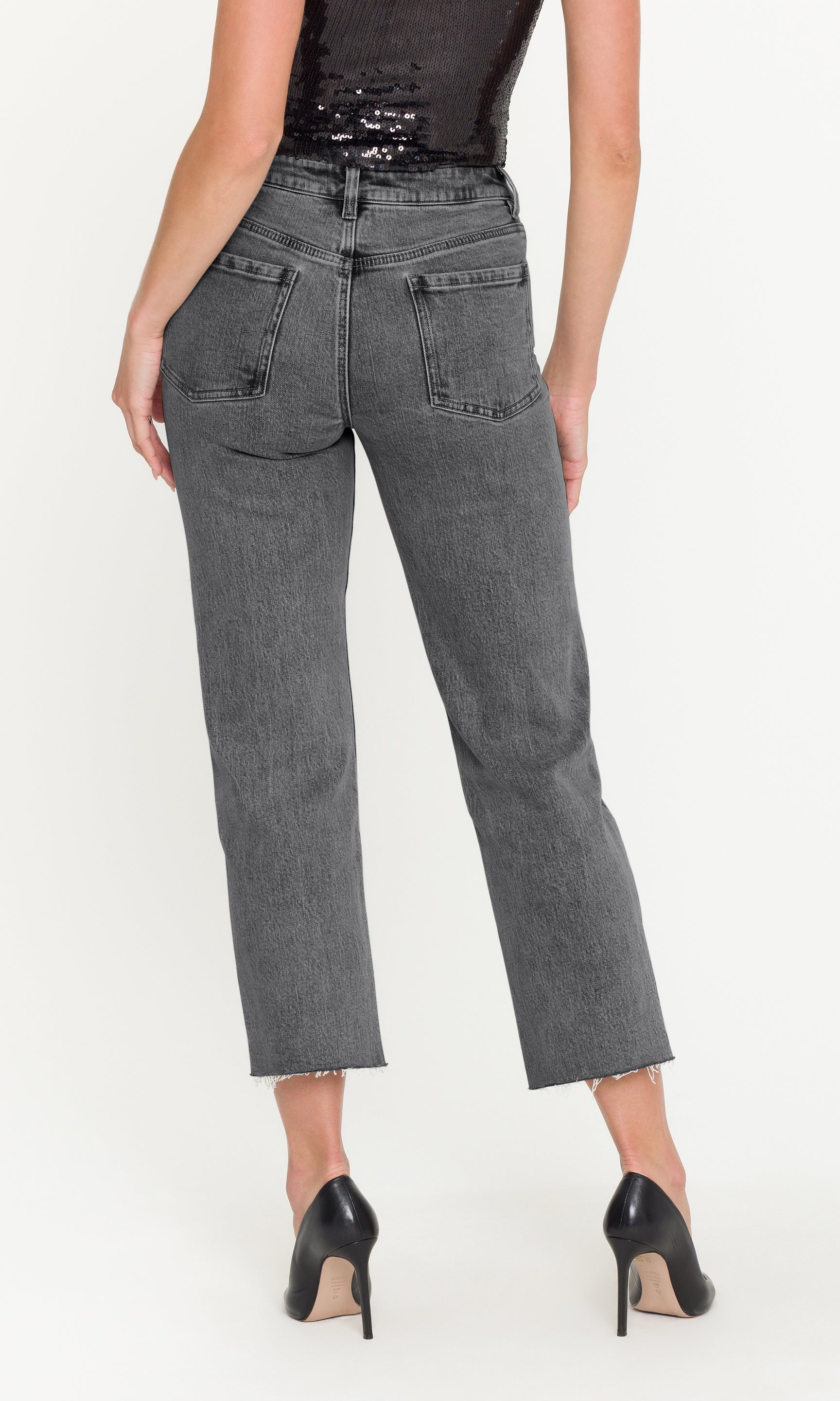 Person wearing gray jeans on a white background