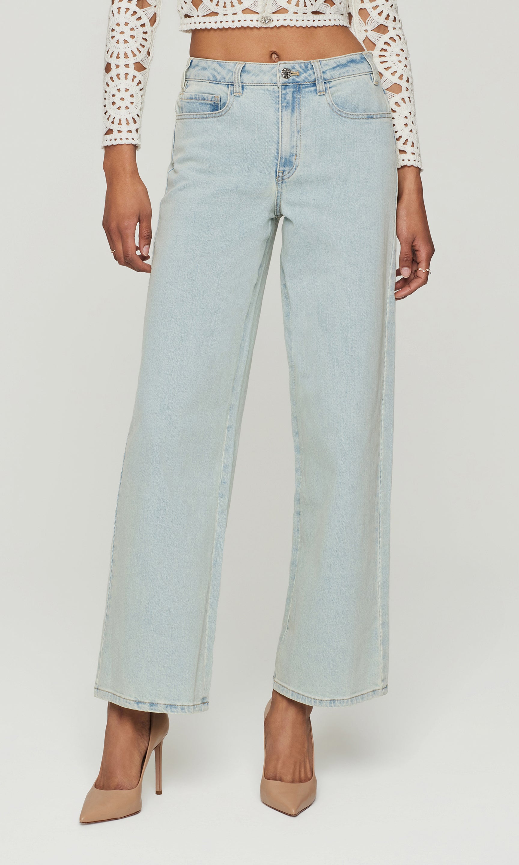 Light blue jeans worn by a person on a white background