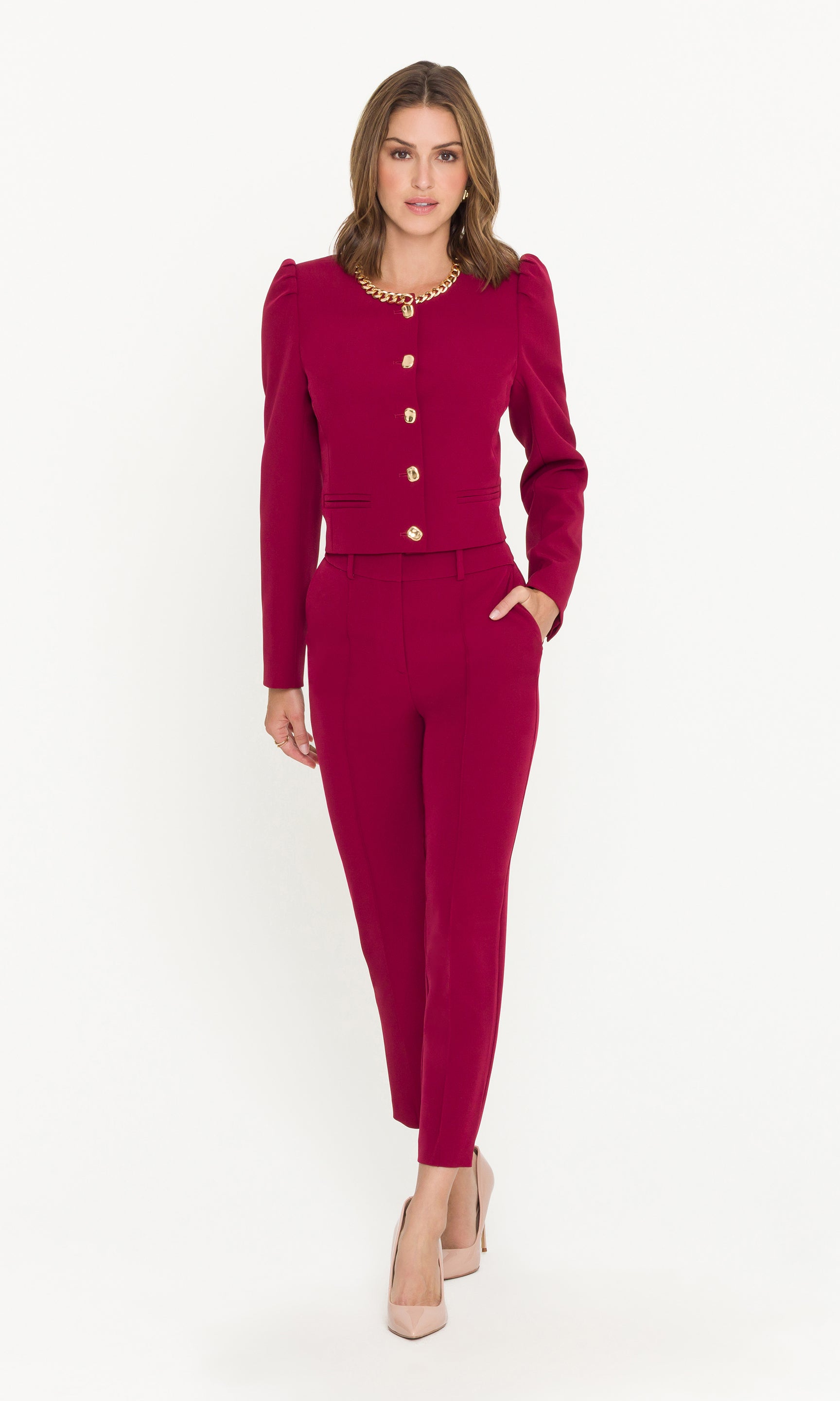 Woman wearing a crimson suit with a white background