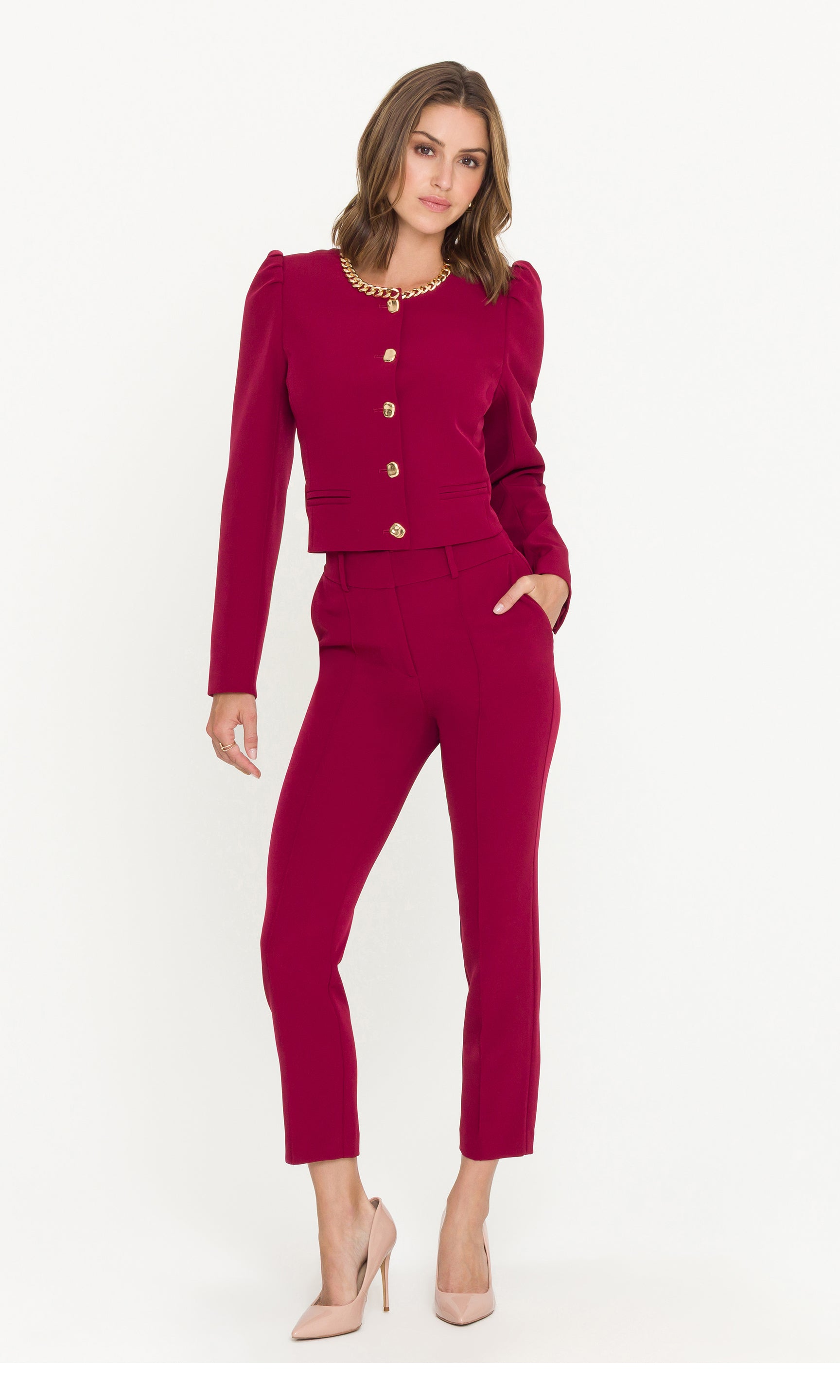Woman wearing a crimson suit with a white background