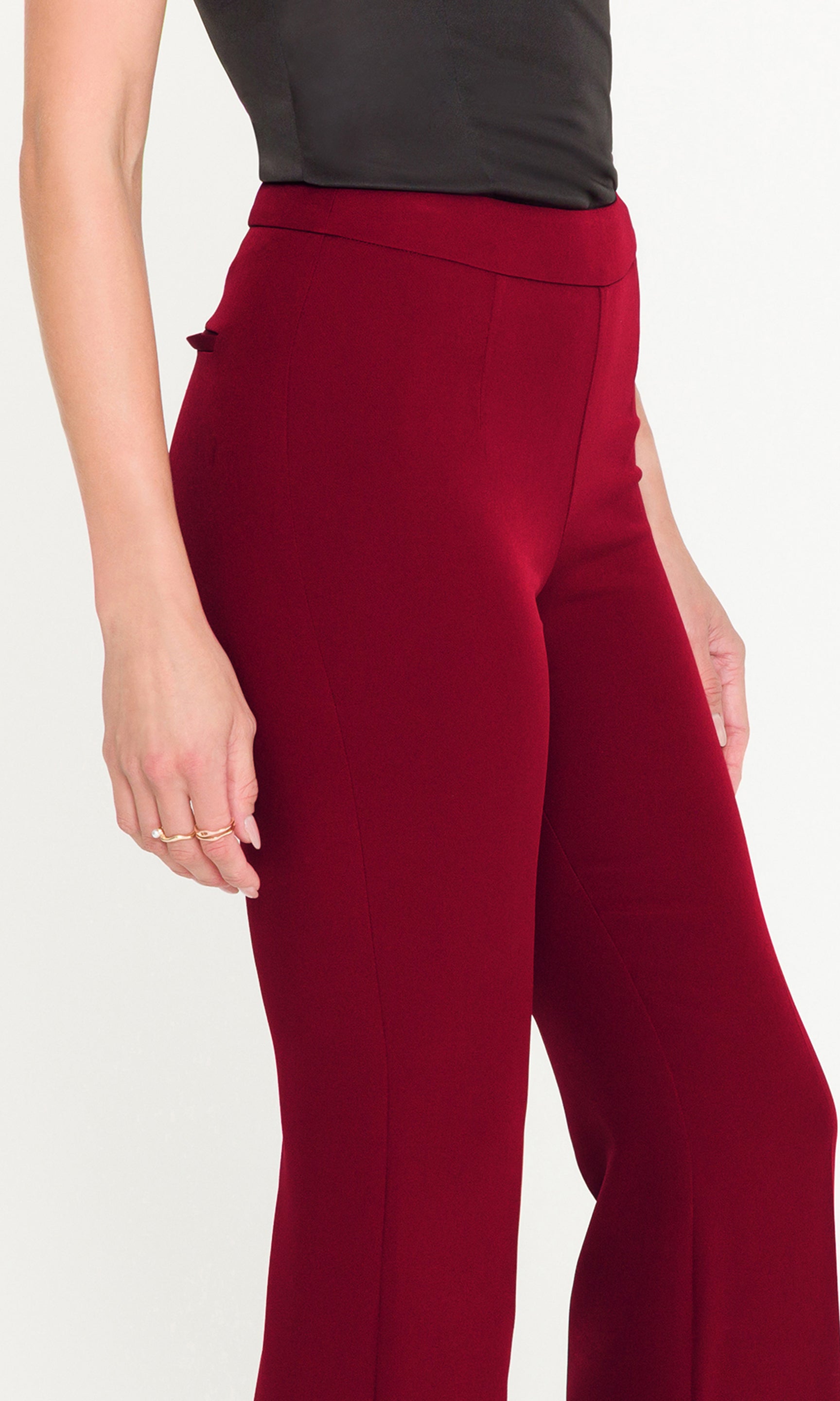 Close-up of red pants worn by a person on a white background