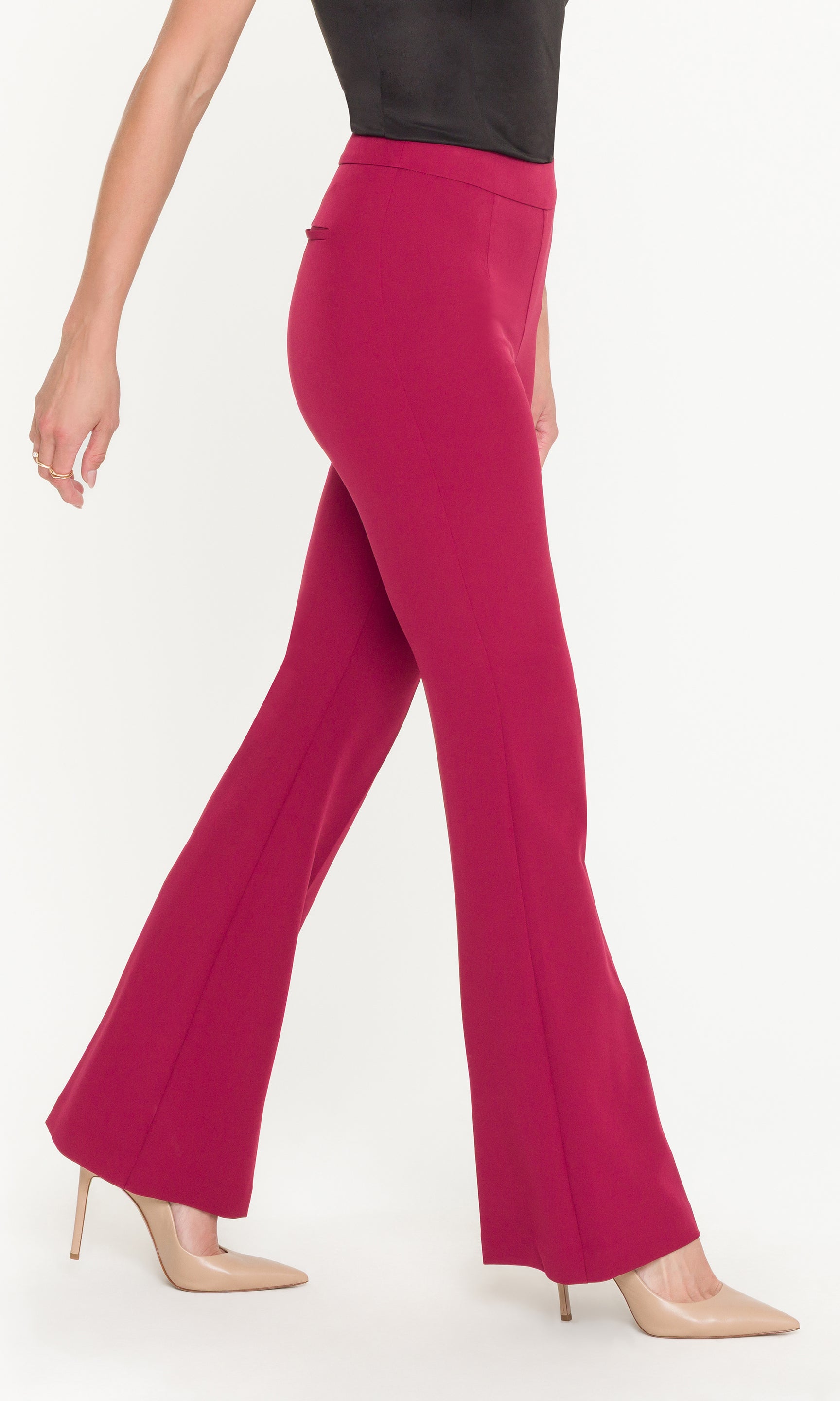 Crimson flared pants worn by a person on a white background