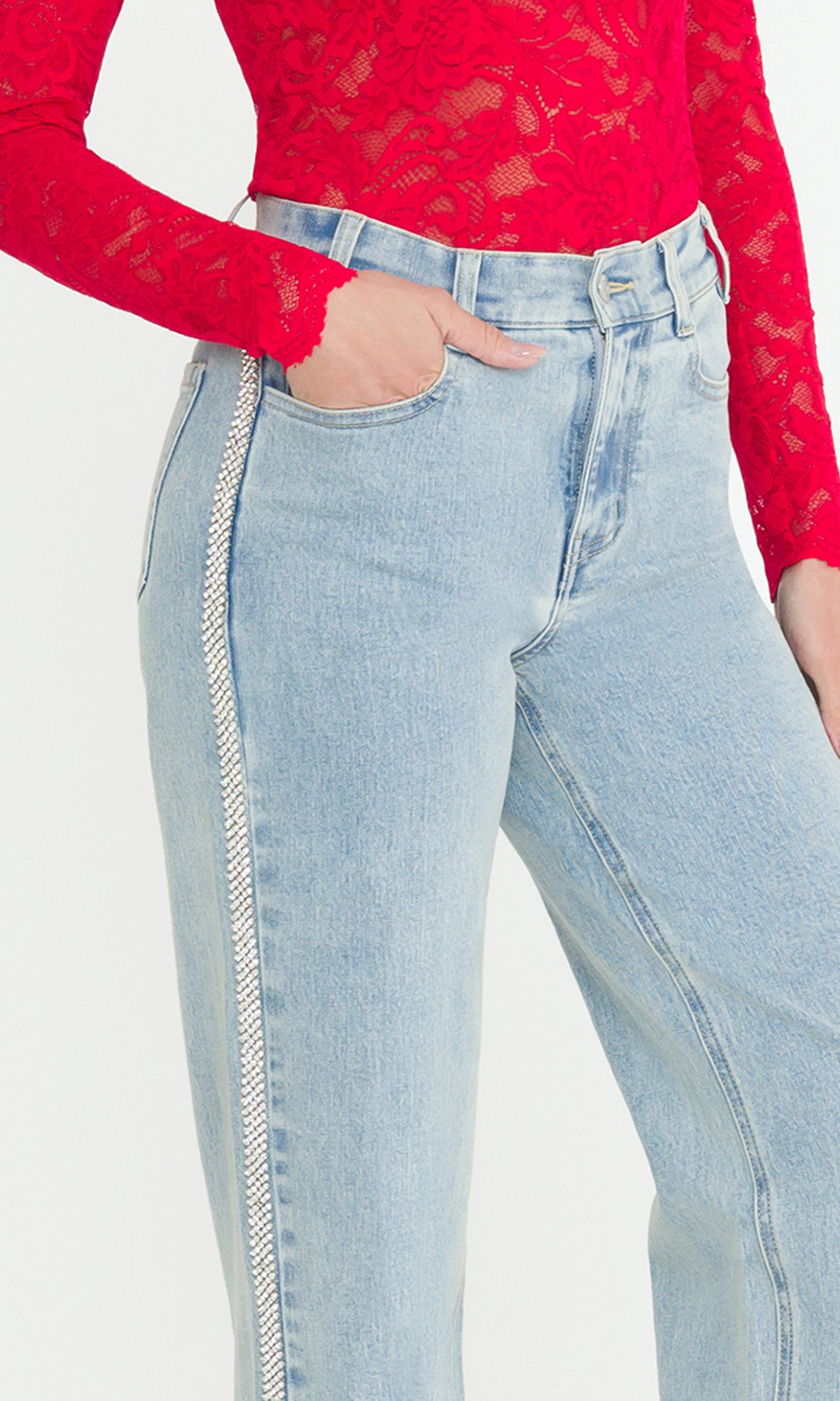 Detail image of model wearing light blue jeans with crystal embellishments down the side of the pant leg.