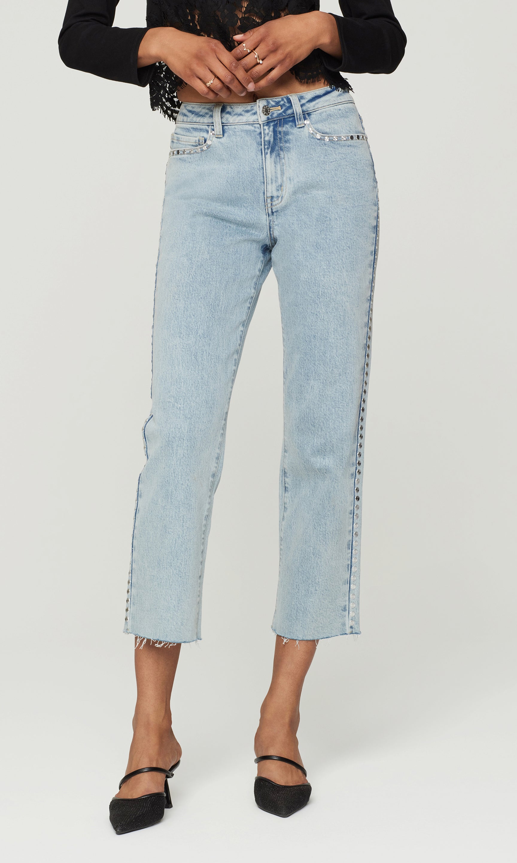 Light blue jeans worn by a person on a white background