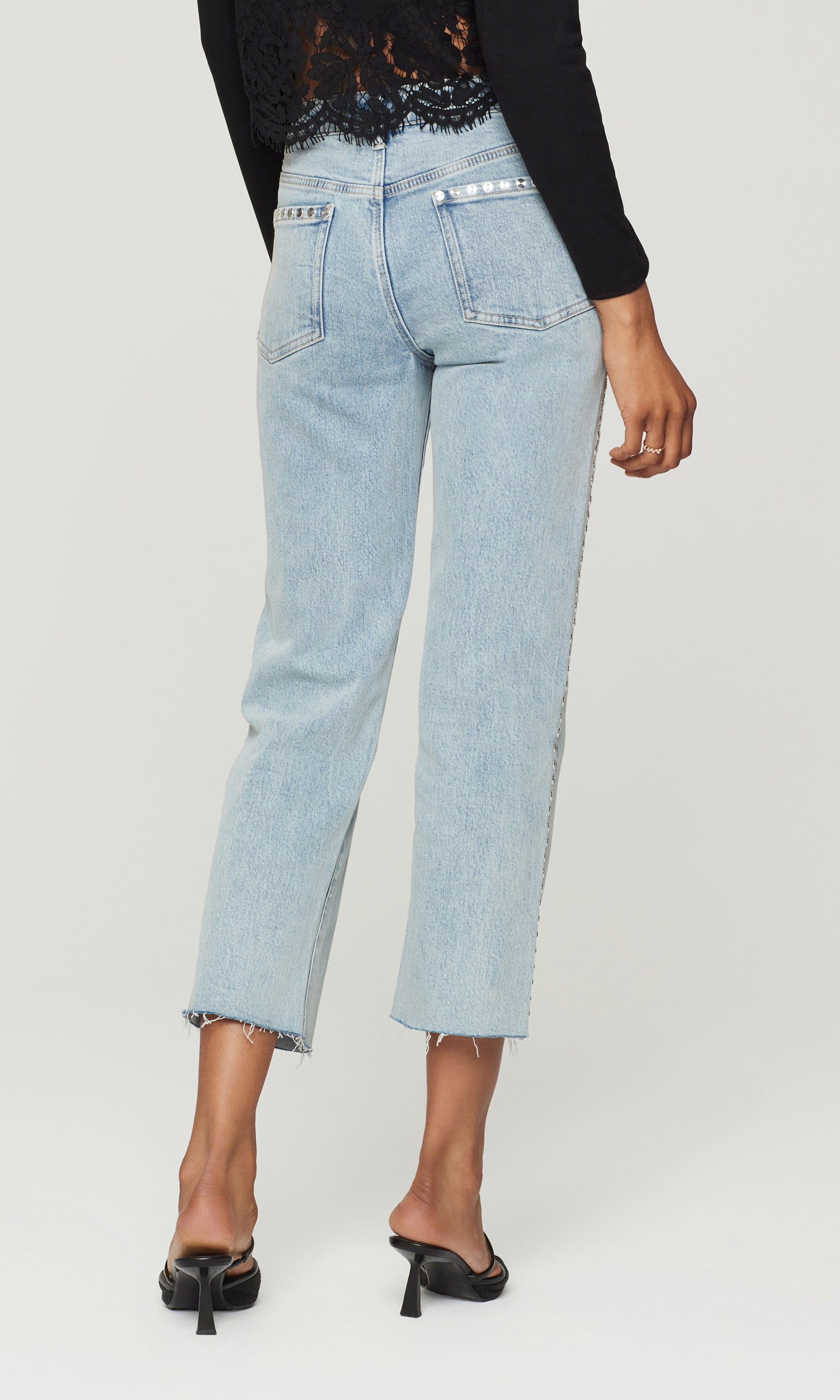 Light blue jeans worn by a person on a white background