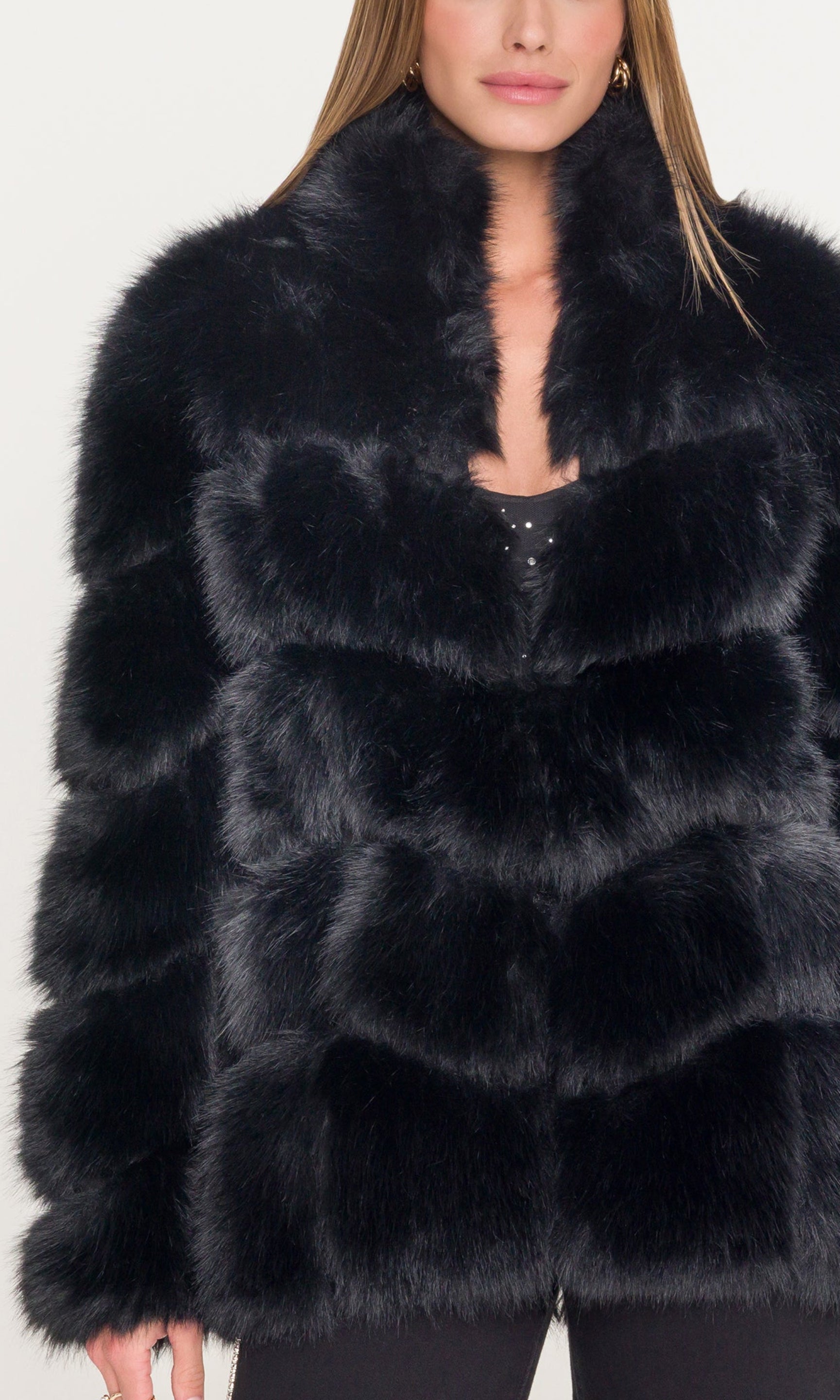 Detail image of woman wearing a black fur coat showcasing the fur detail