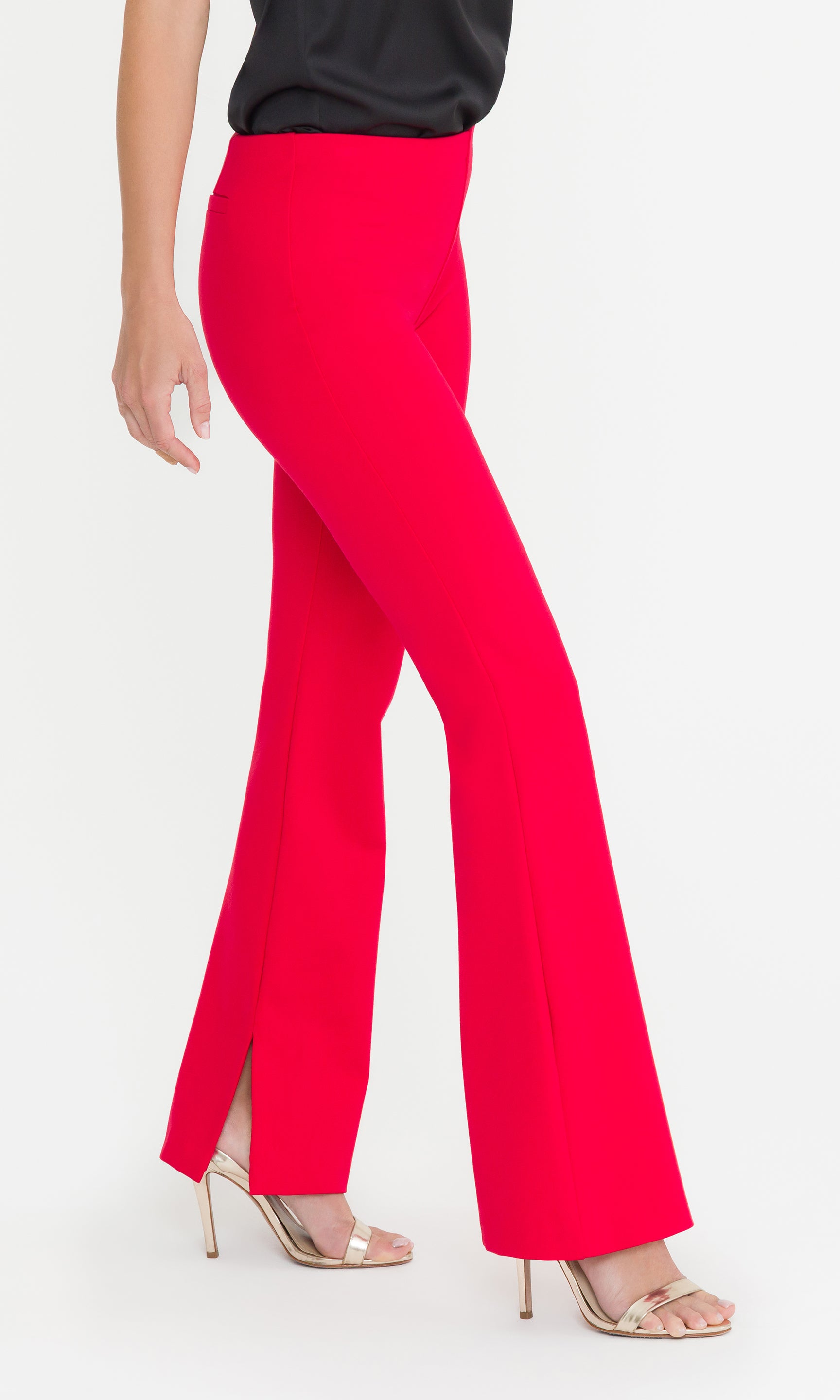 Side view crop image of red flared pants worn by a person on a white background