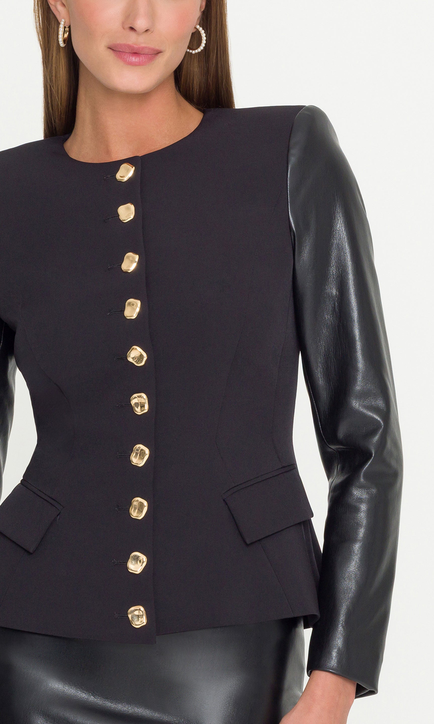 Black jacket with gold buttons and leather sleeves on a white background