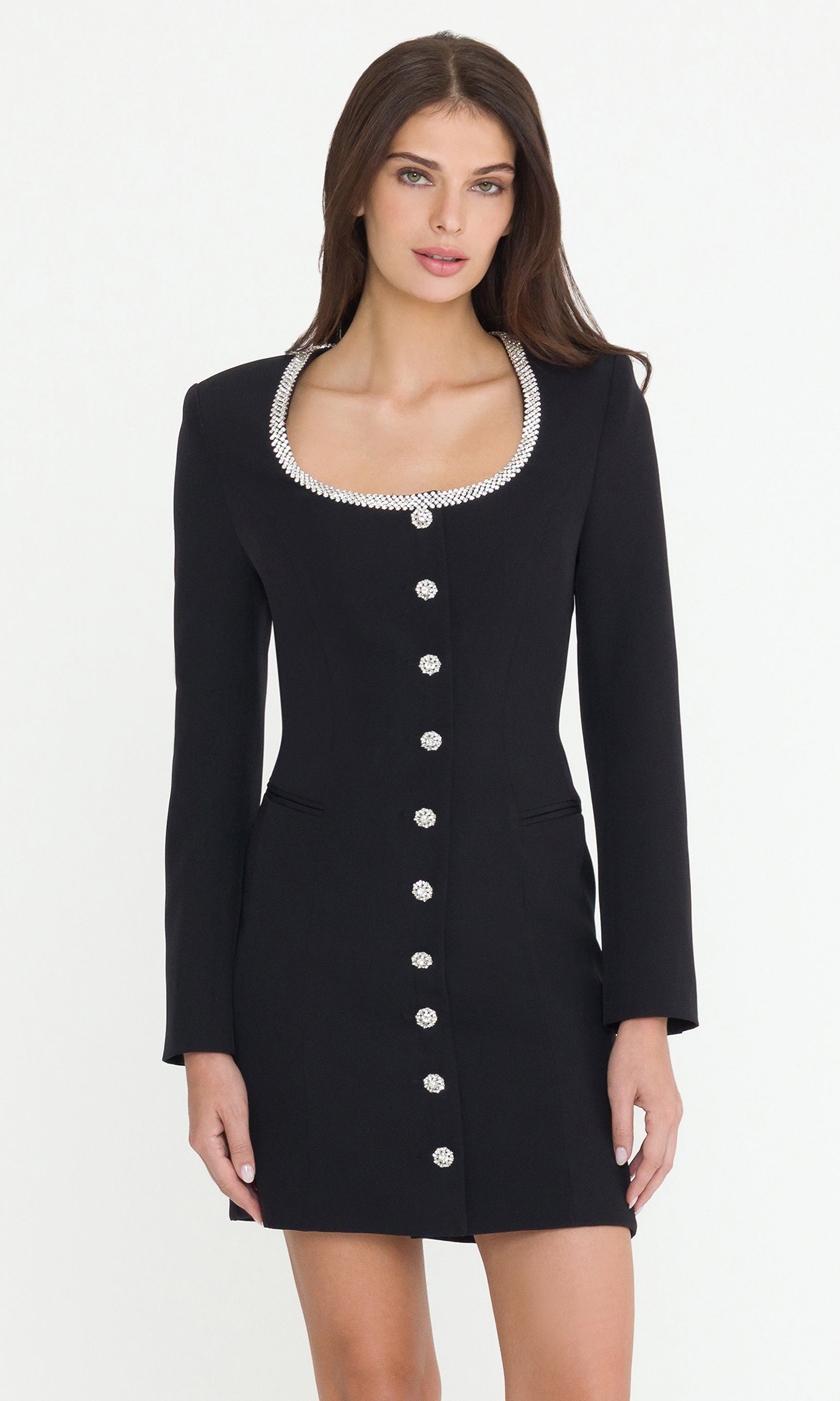 Woman wearing a black dress with crystal buttons and crystal neckline on a white background