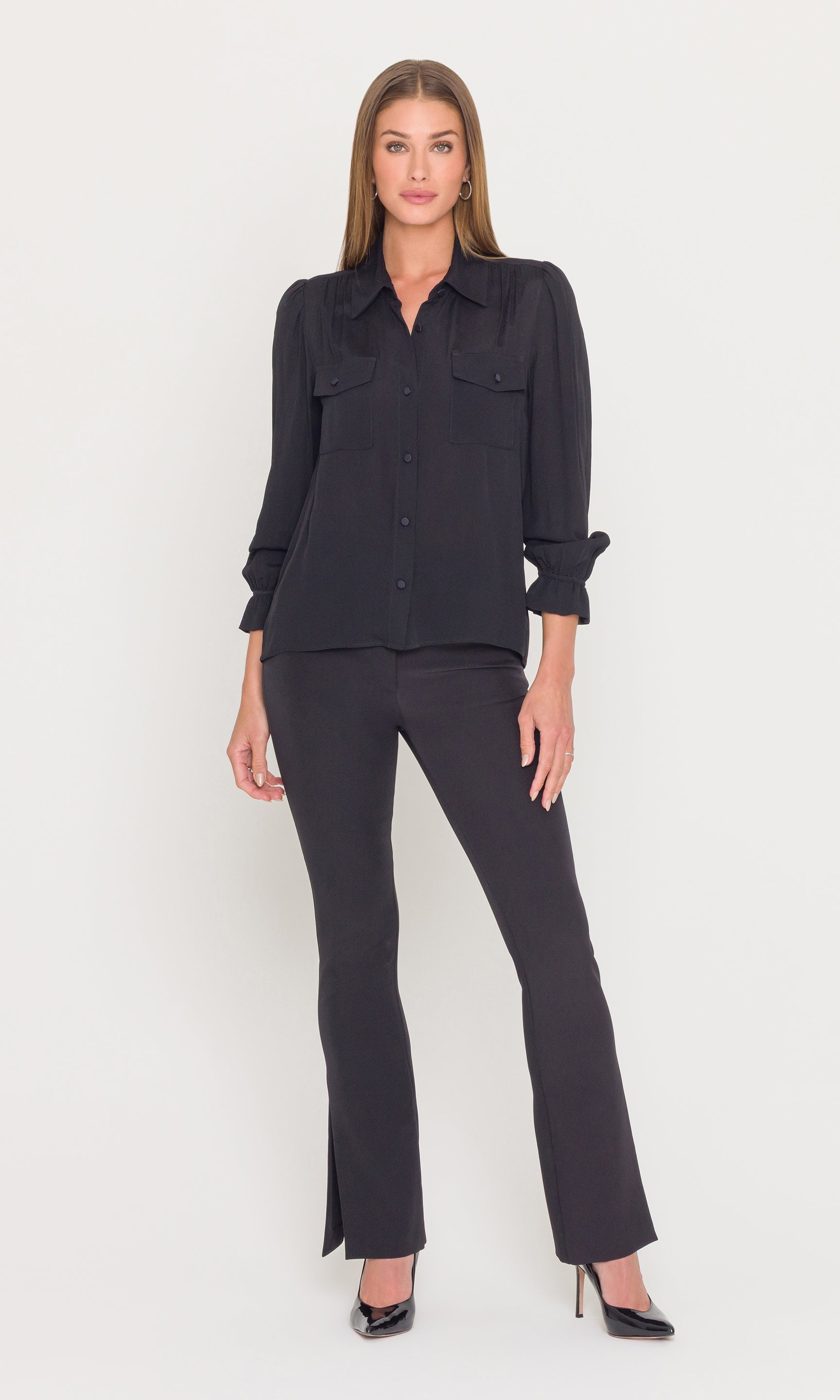 Woman wearing a black outfit on a white background