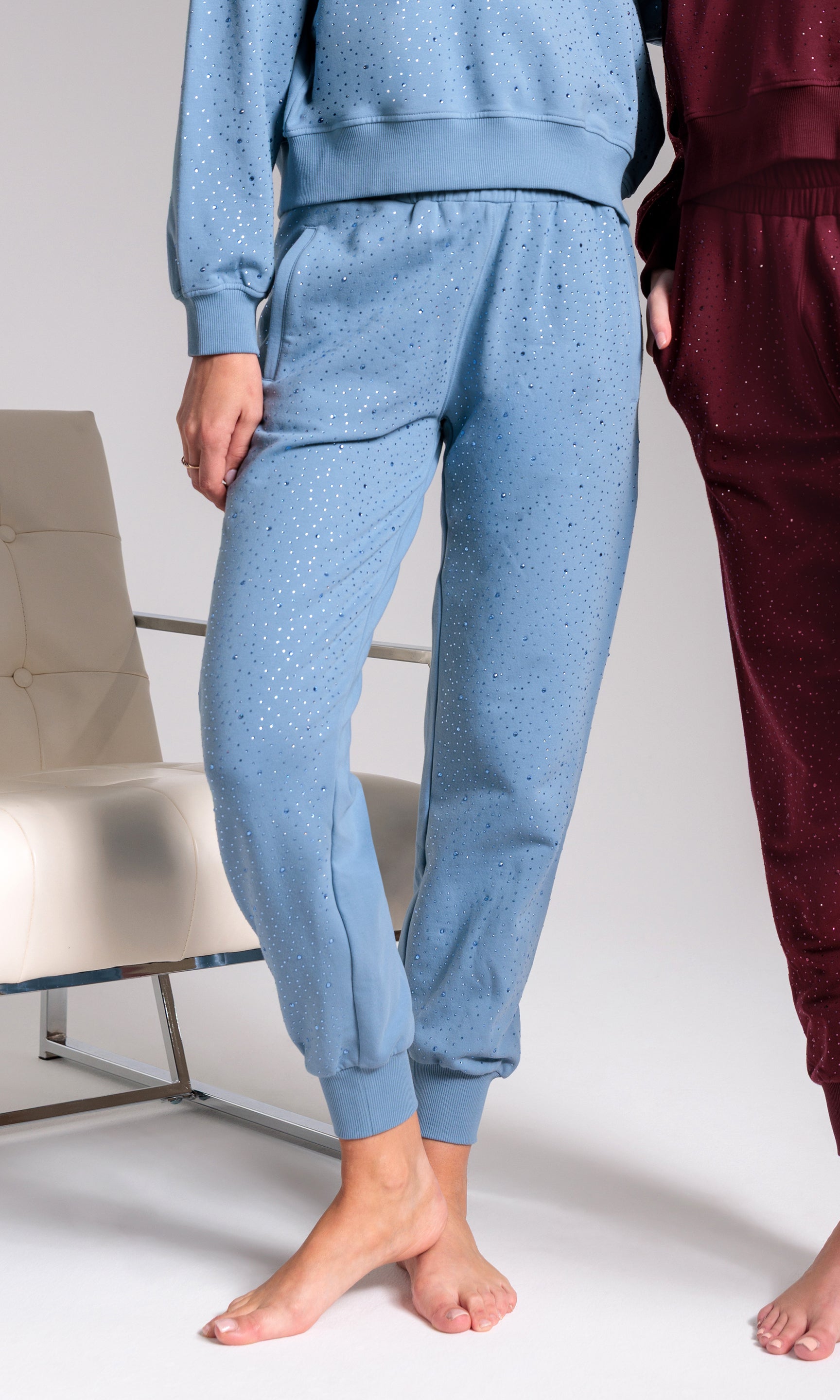 Person wearing blue pajama set with maroon pants in the background