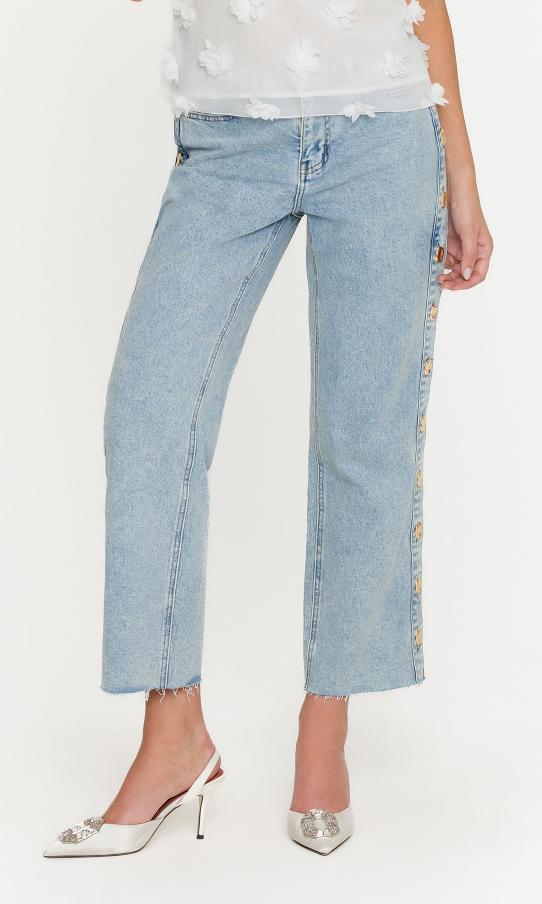 Light blue jeans with floral accents on a white background