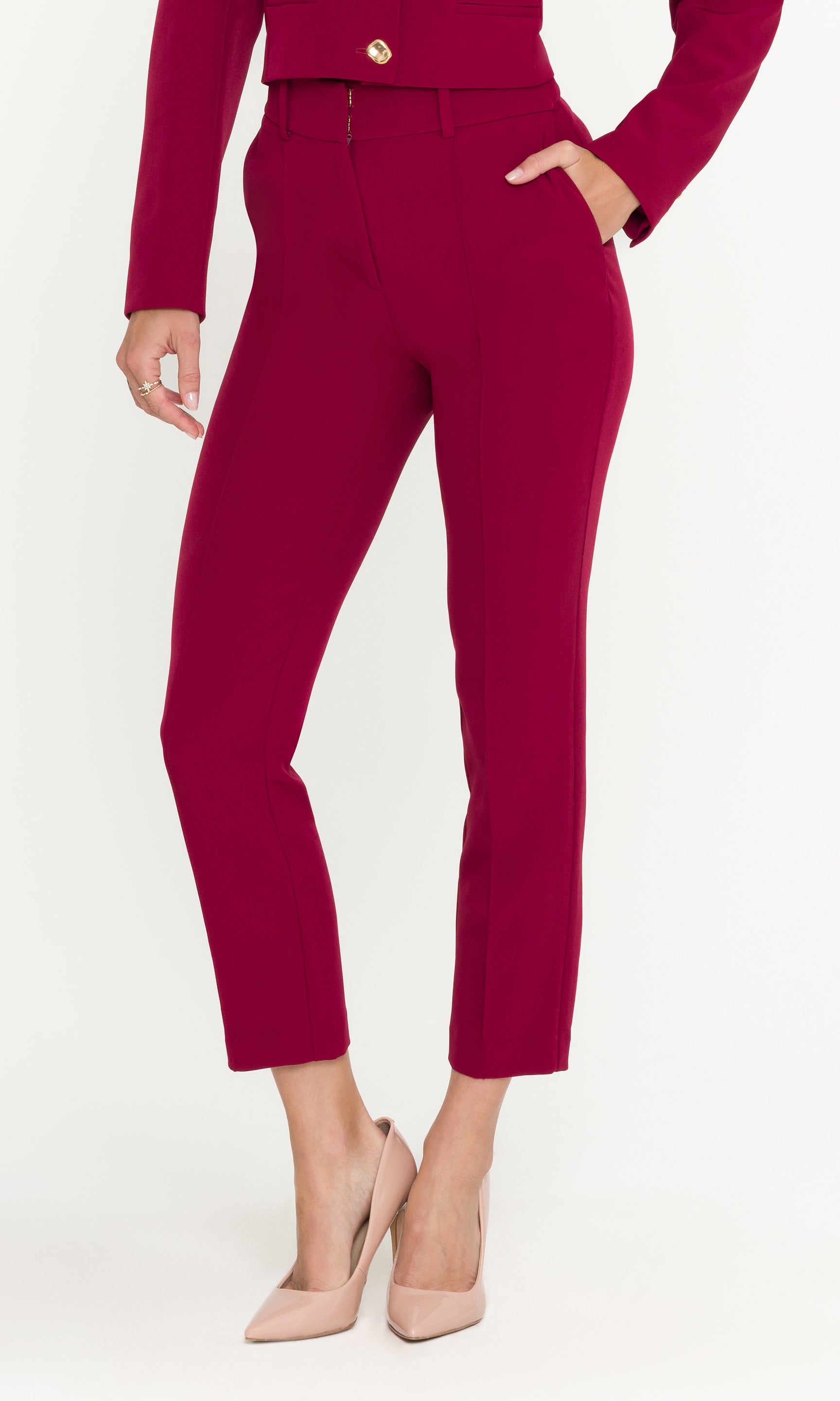 Person wearing a red outfit with high-waisted pants on a white background