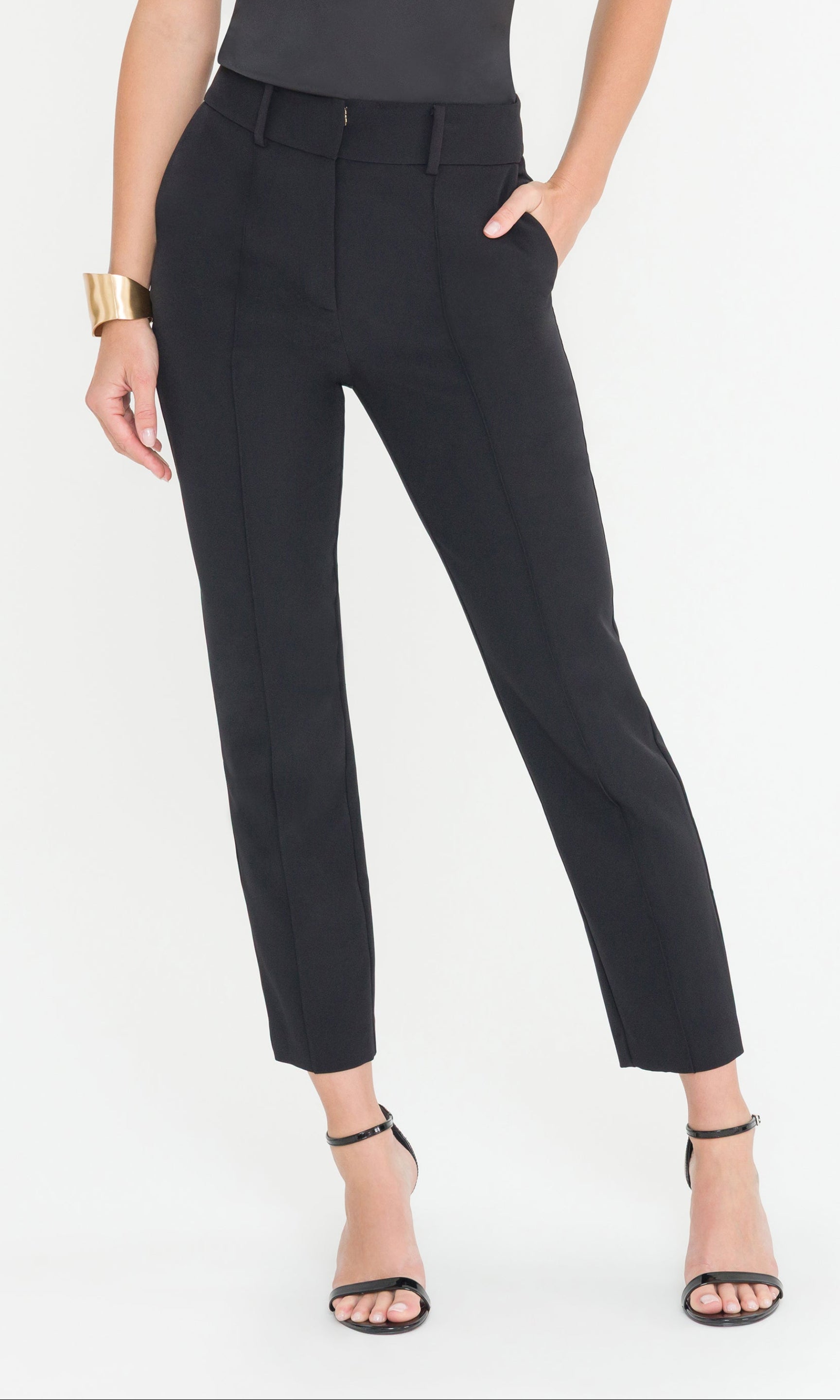 Black pants worn by a person on a white background