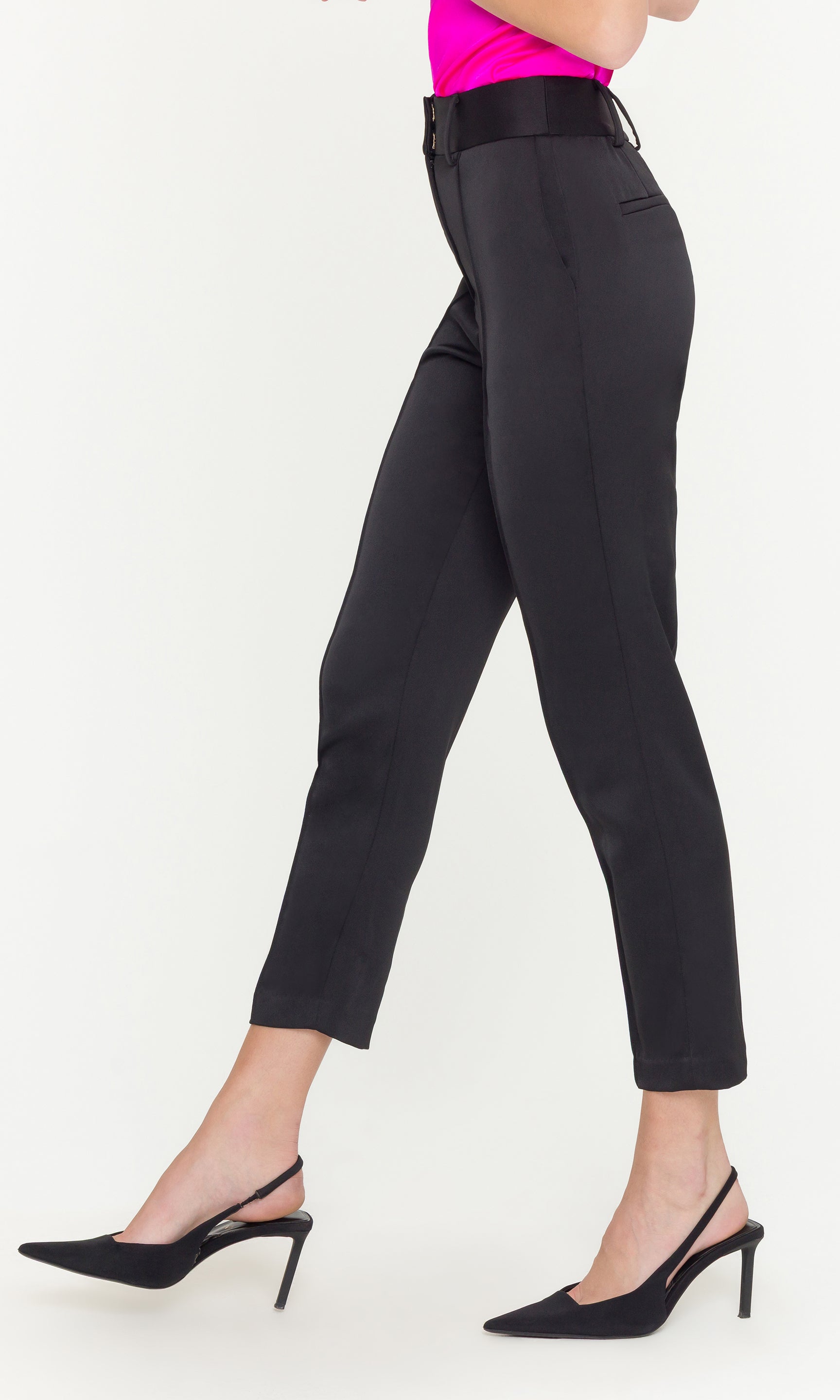 Black pants worn by a person on a white background