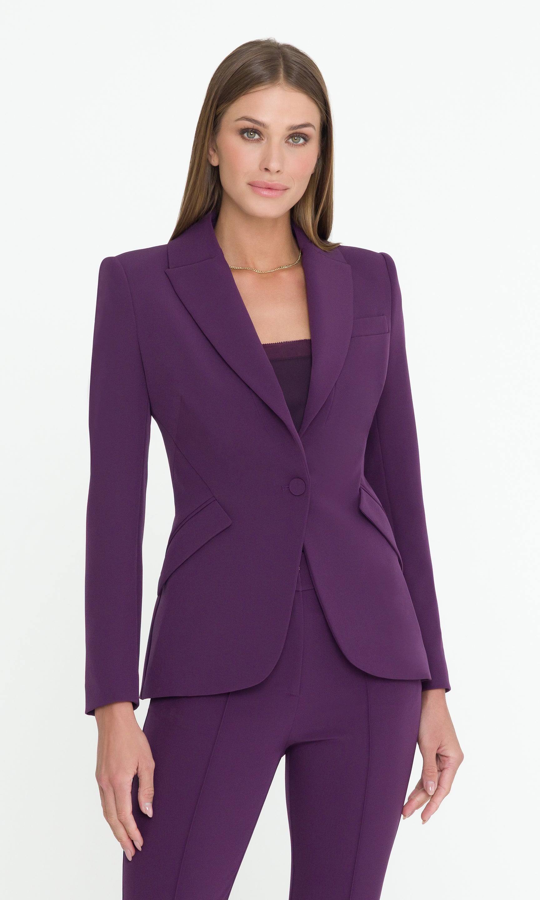 Woman wearing a purple suit on a white background