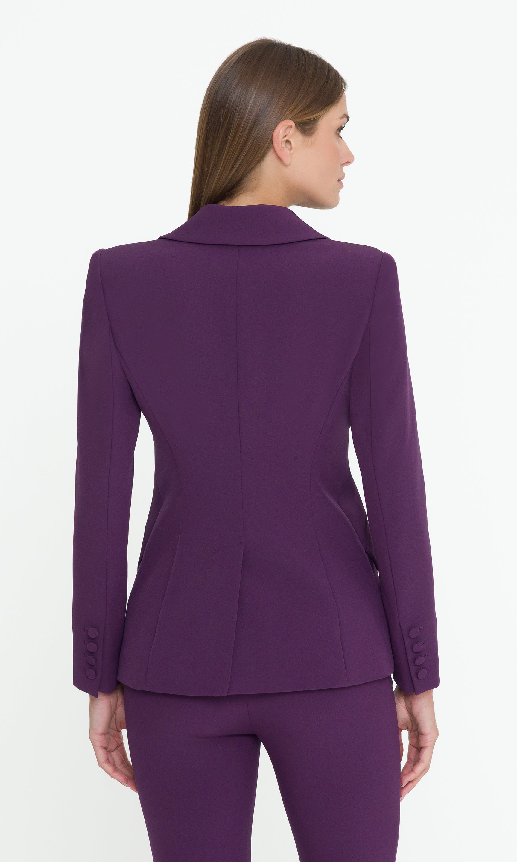Back vview of Purple suit jacket worn by a model on a white background