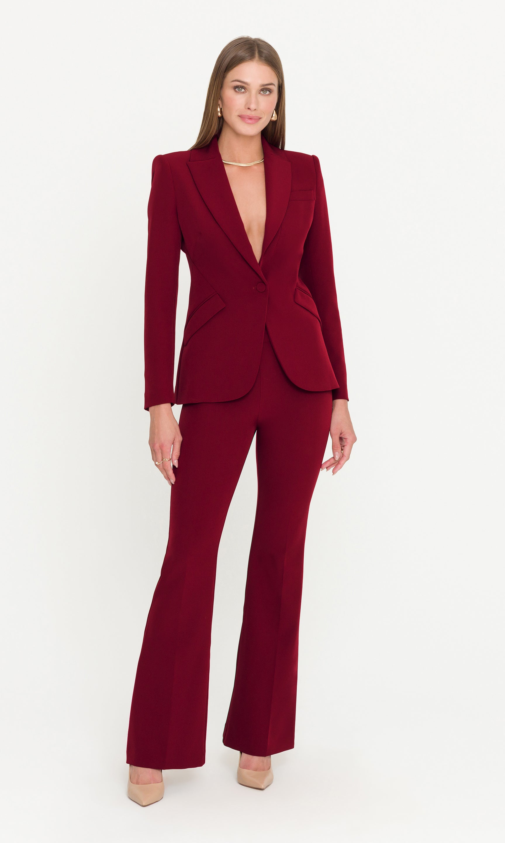 Woman wearing a burgundy suit on a white background