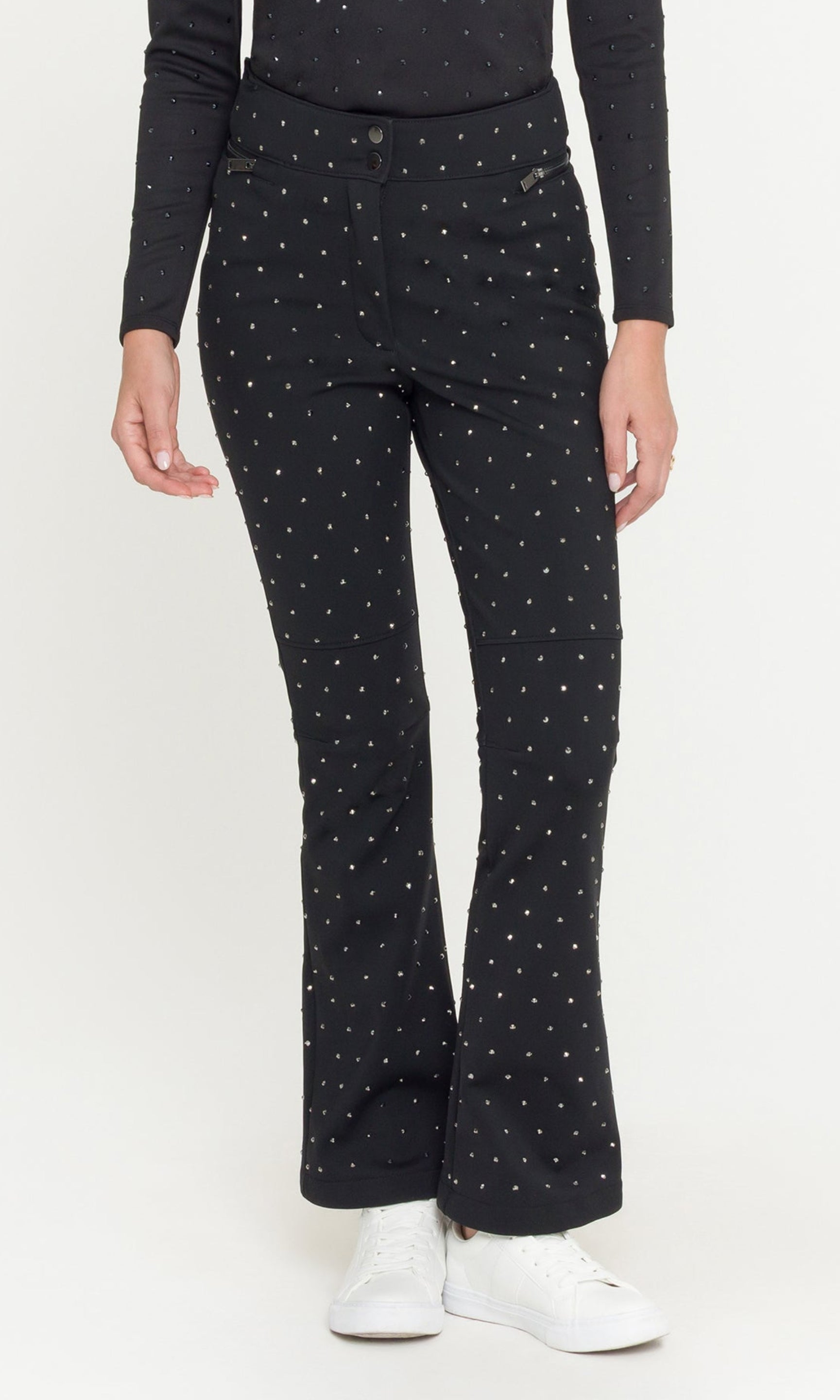 Woman wearing a black outfit with crystals on a white background