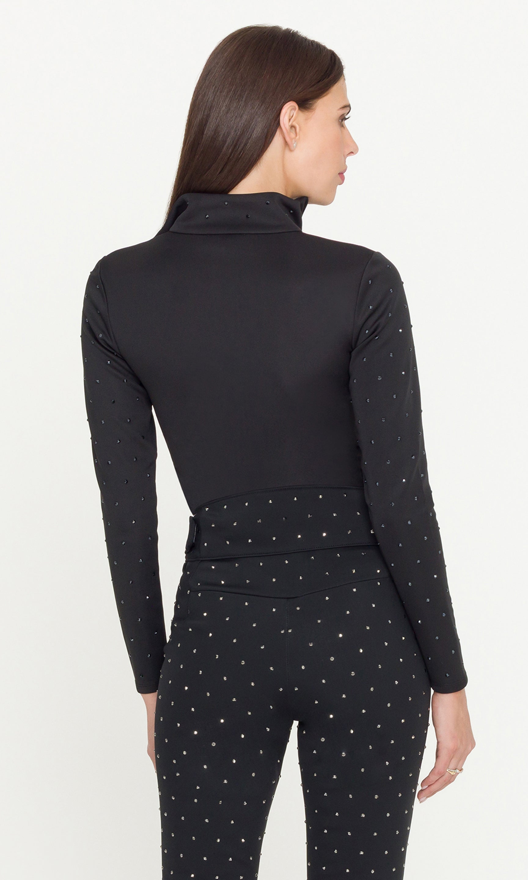 Woman wearing a black outfit with a pattern on a white background