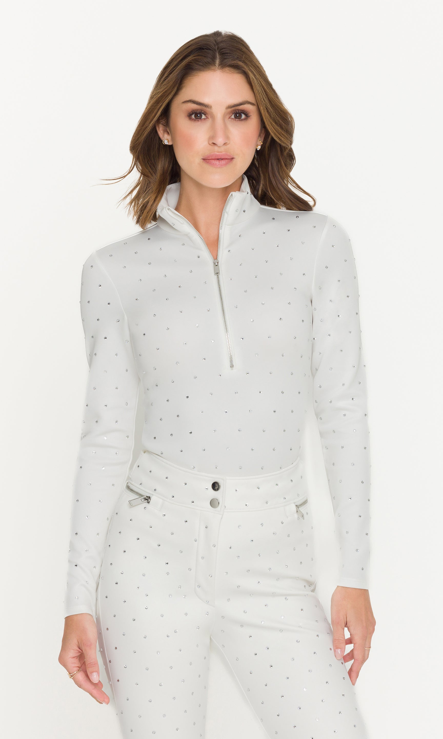 Woman wearing a light gray zip-up jacket with a white background