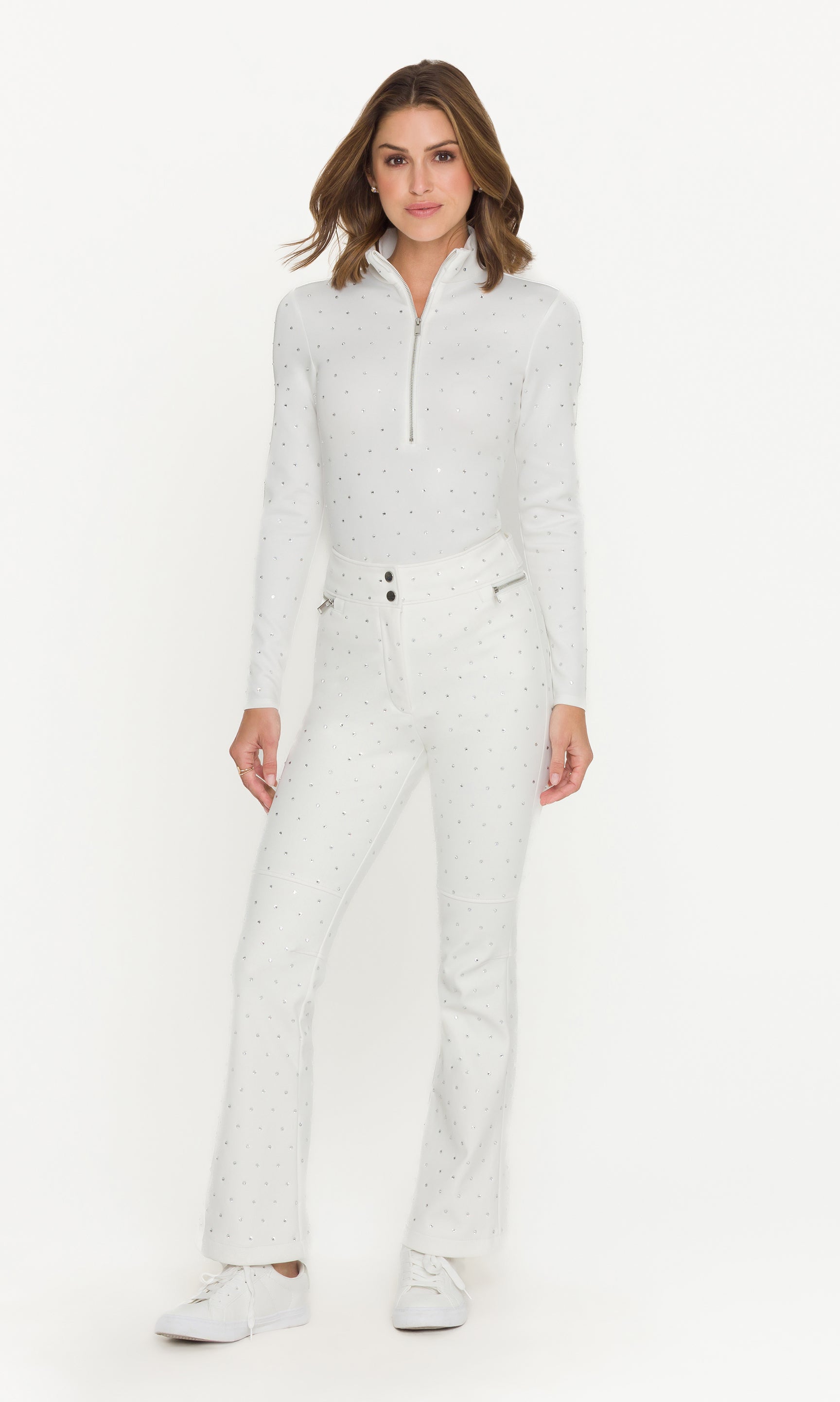Woman wearing a white ski outfit on a white background
