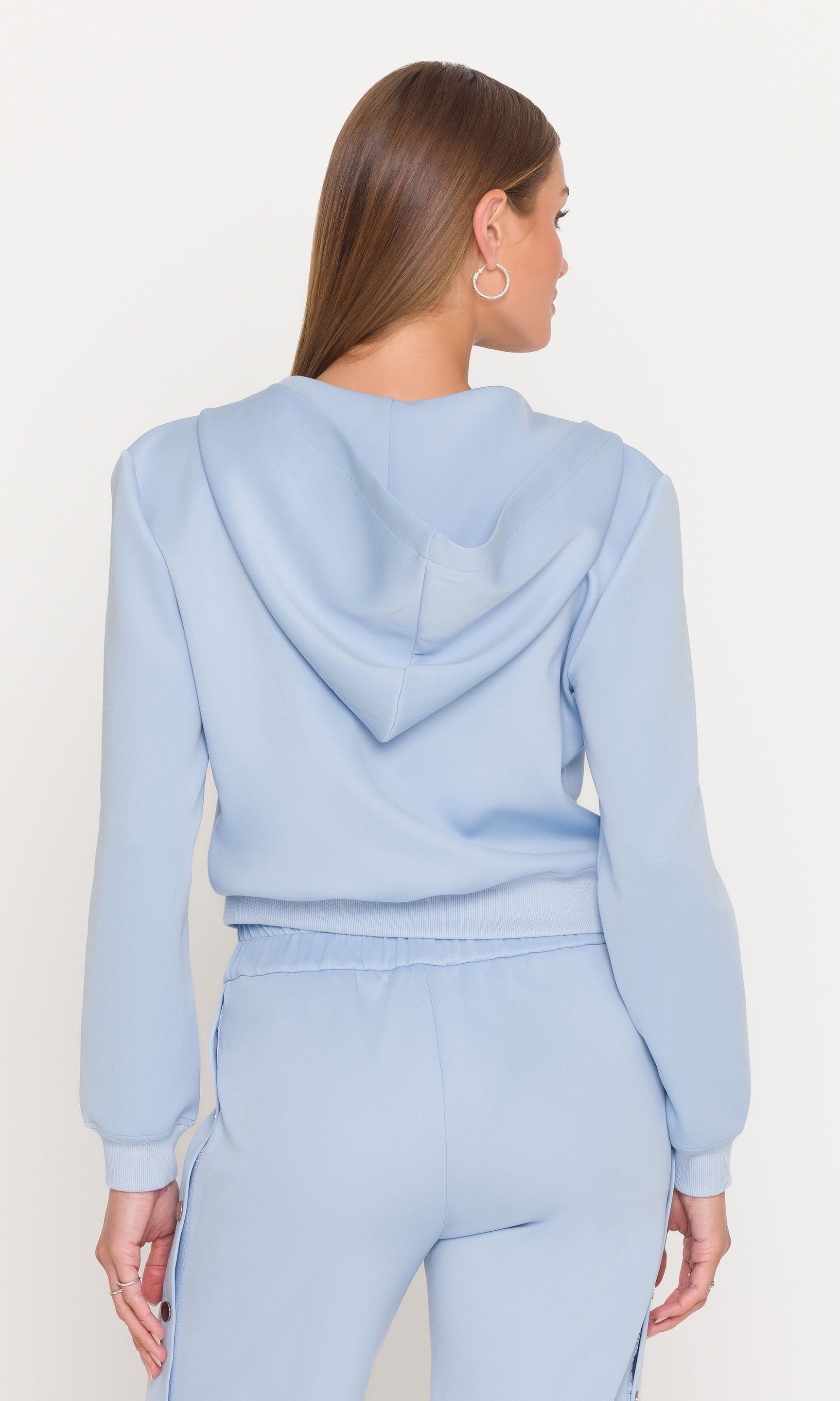 Back view of light blue hoodie and pants set on a white background