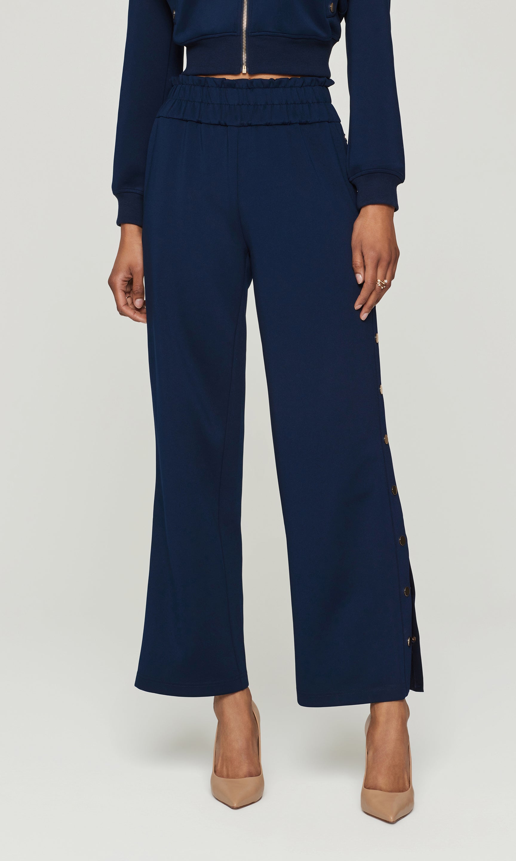Navy blue outfit with high-waisted pants and matching top on a white background