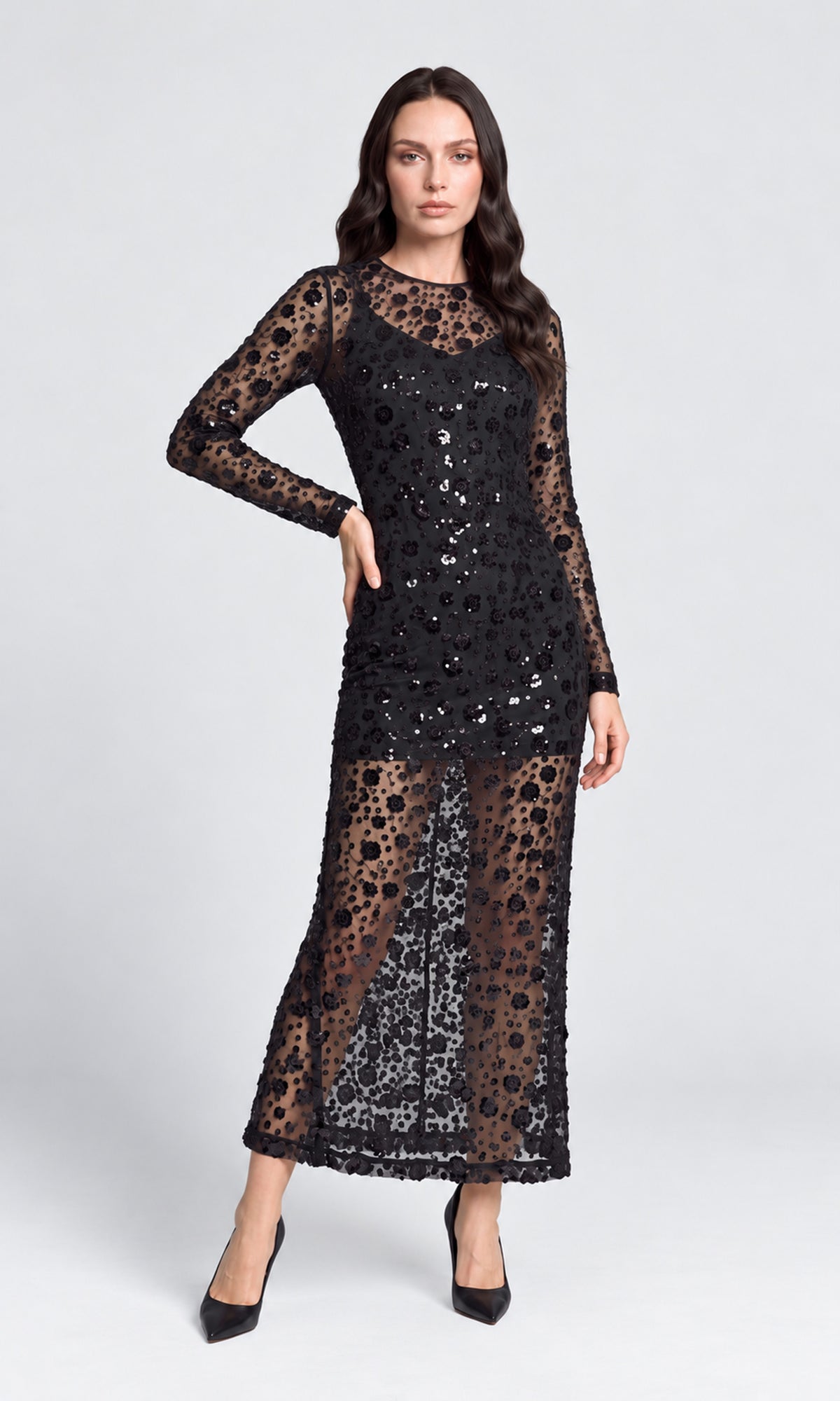 Model wearing a long-sleeve black lace maxi dress with sequined floral detailing.