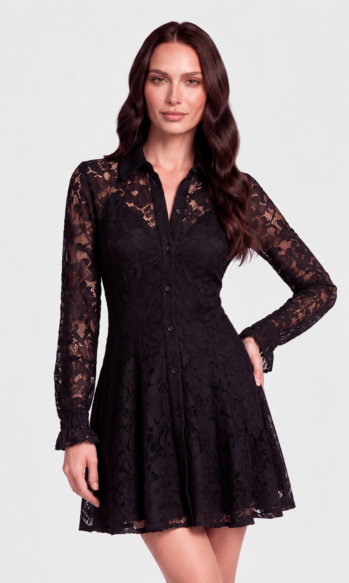 A woman modeling a black lace long-sleeve mini dress with a button-down front and flared skirt.