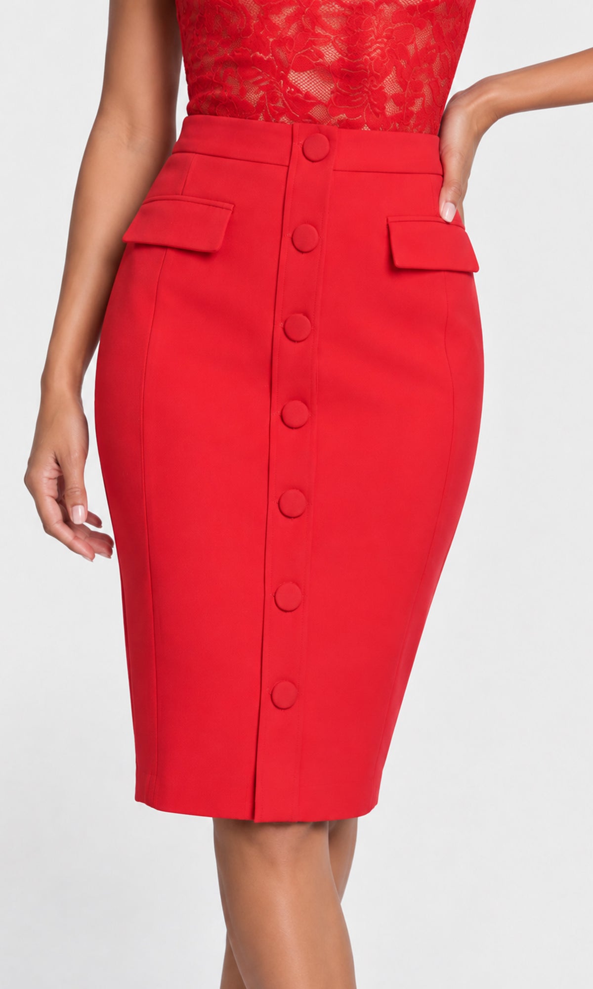 Close-up of a bright red knee-length pencil skirt with a high waist, front button closure, and flap pockets.