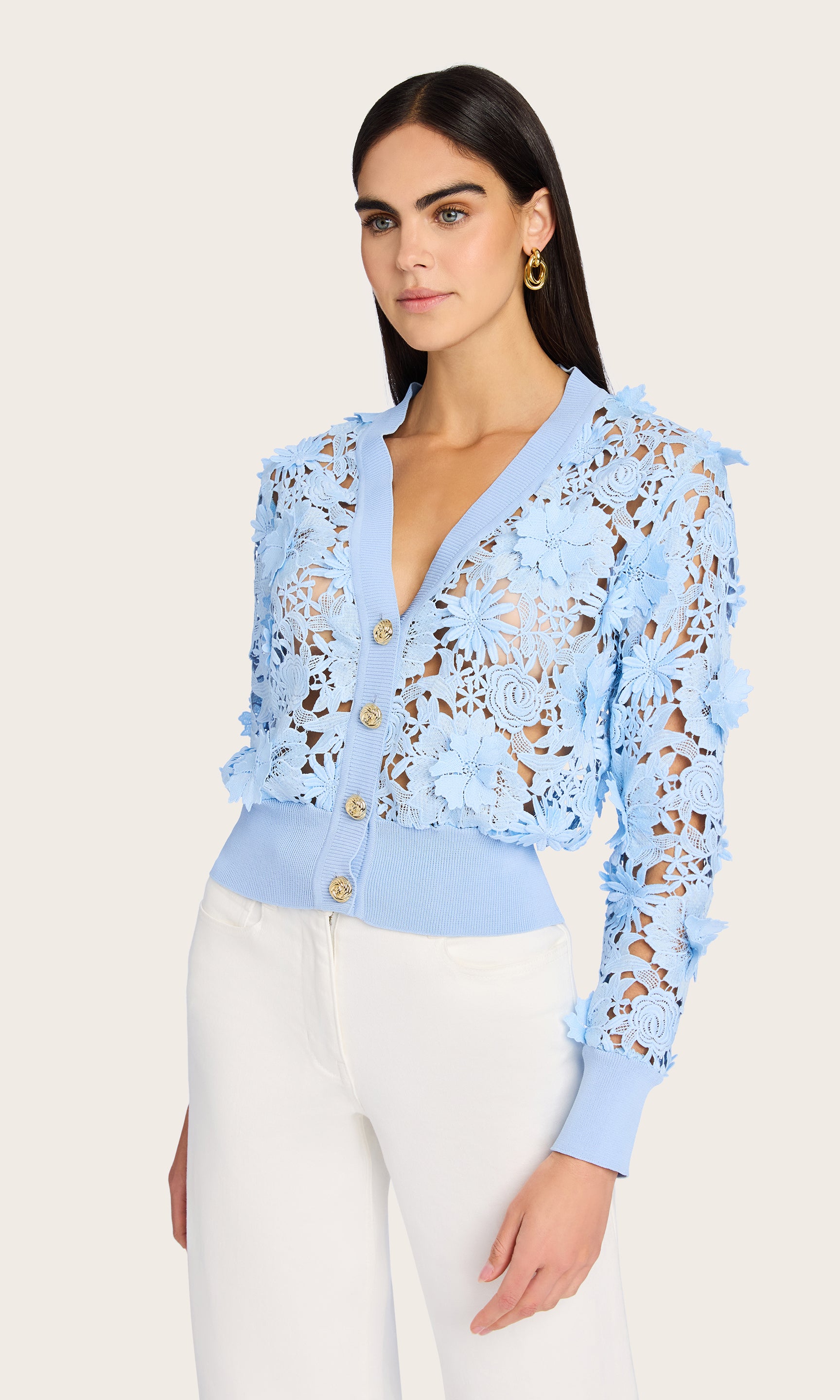 Side view of the Harlow Lace Cardigan on the model, offering a profile glimpse of its feminine silhouette and airy lace texture.