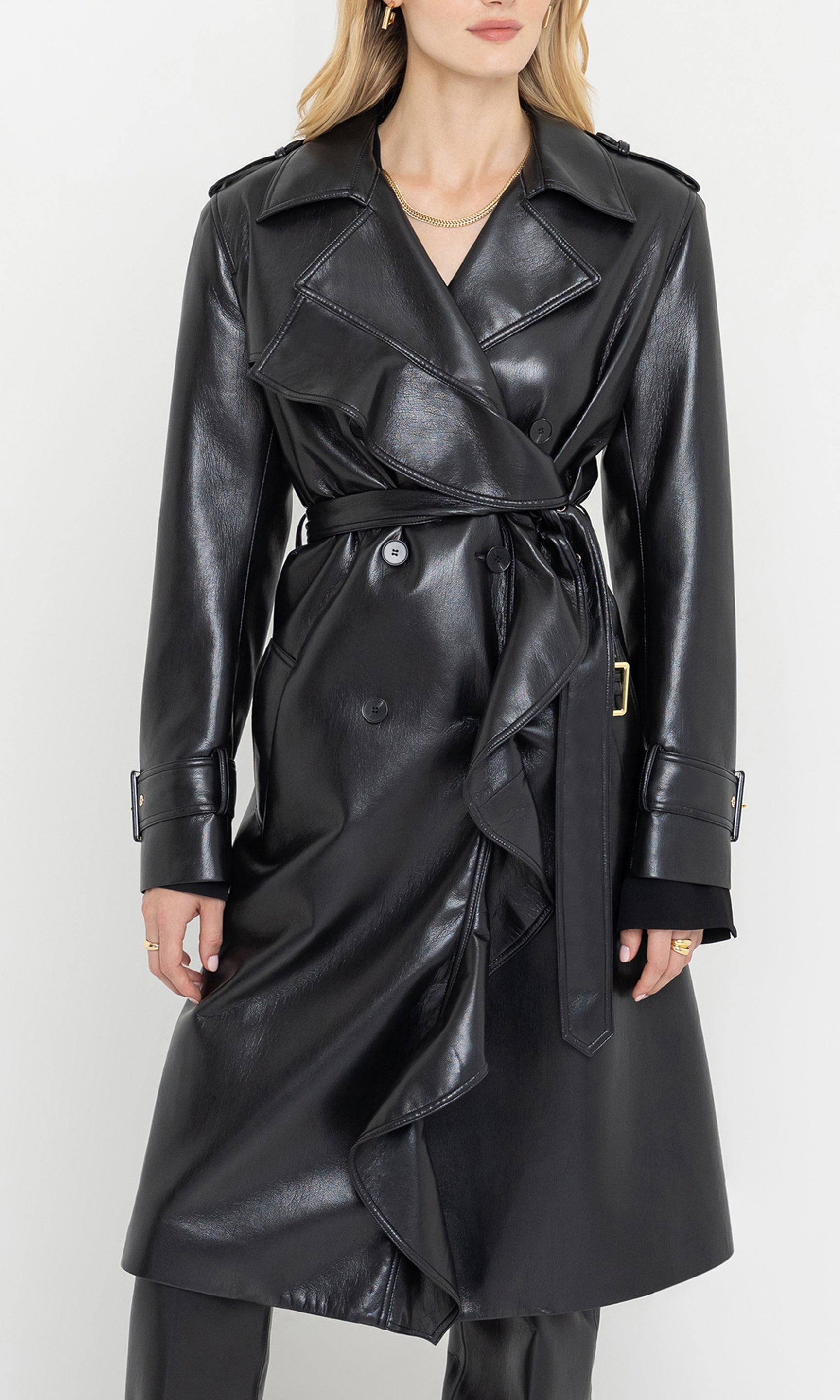 Black leather trench coat worn by a model on a white background