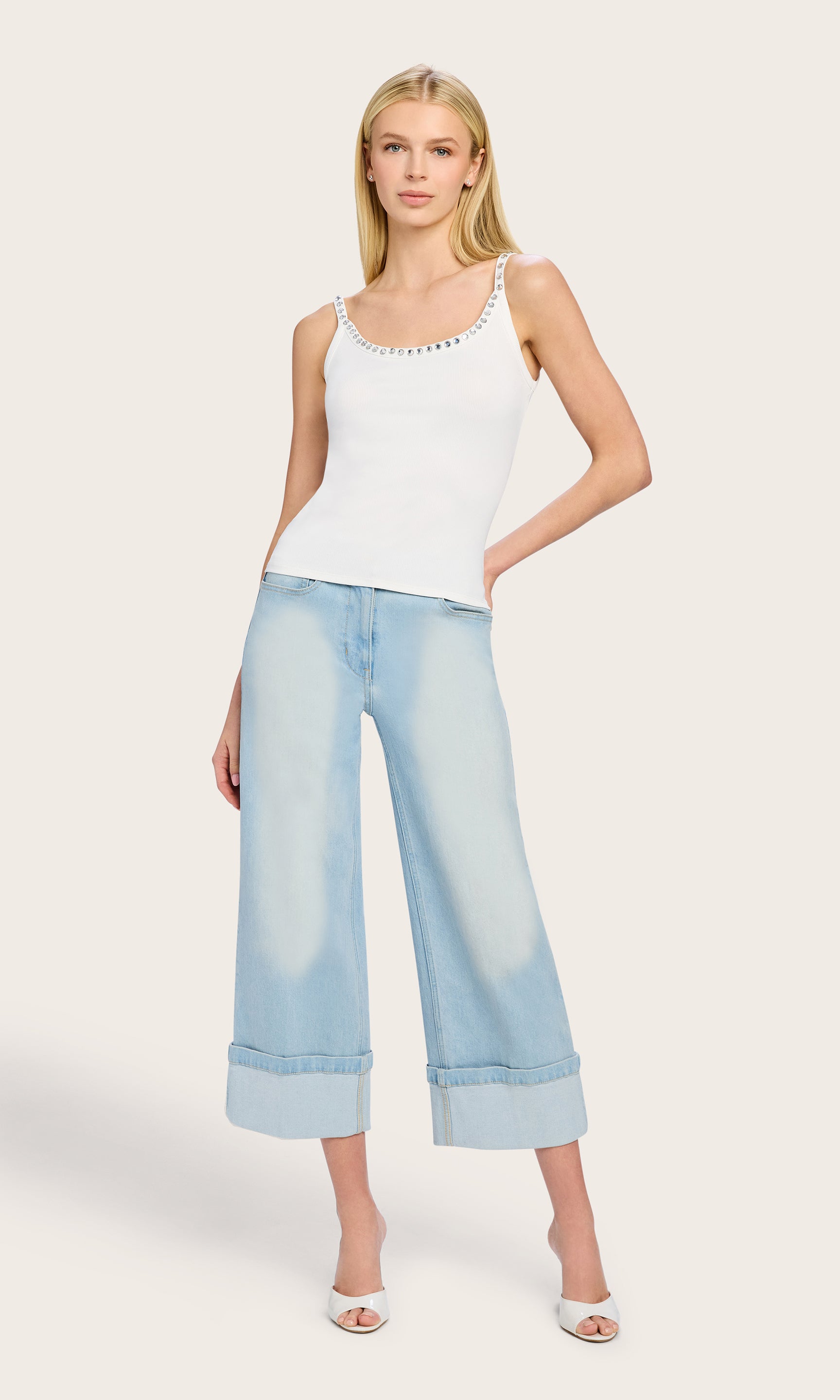 Full body view of the model wearing the white Iris Crystal Tank Top and wide-leg jeans, styled for a light and relaxed daytime outfit.