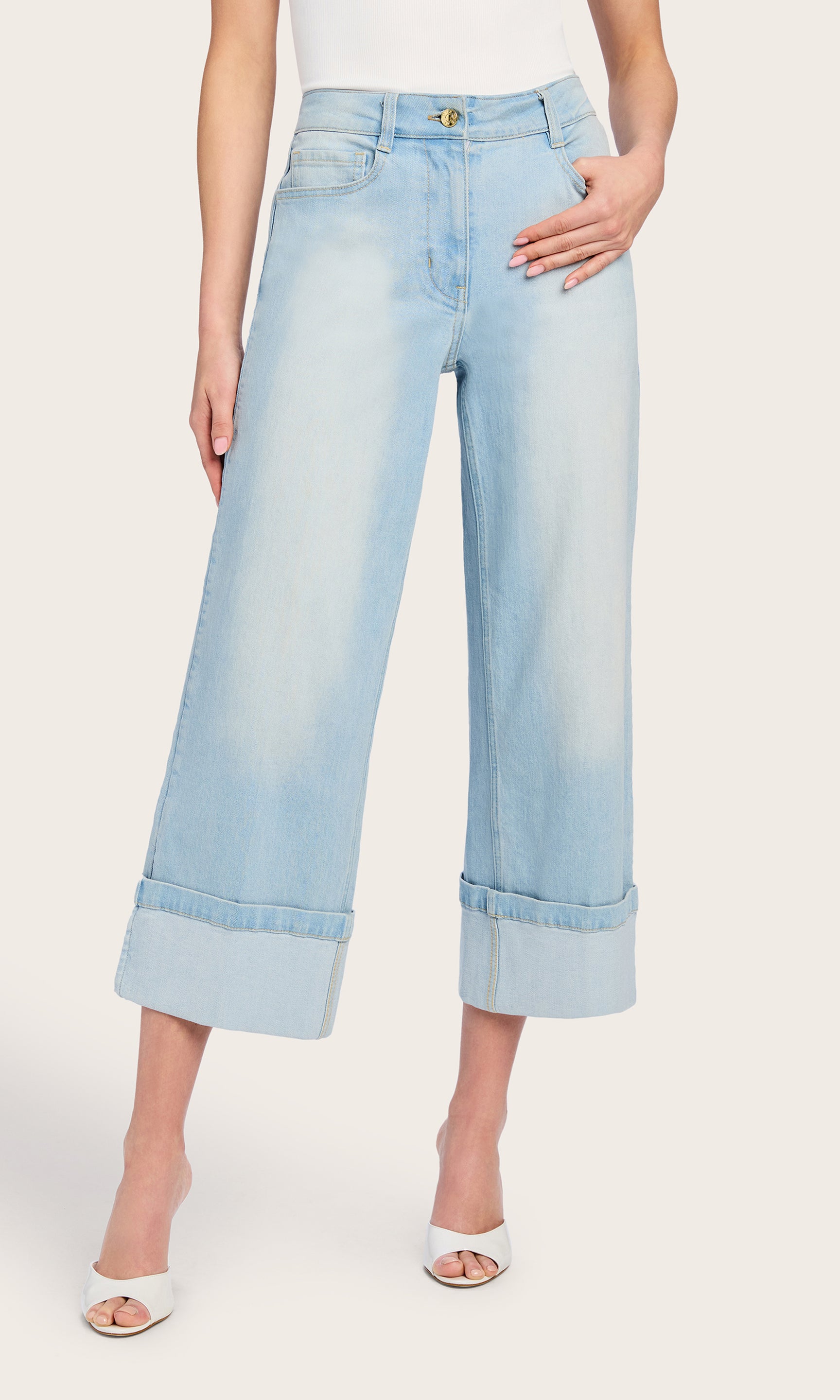 The model wears the Eros Denim Pant in a front-facing view, styled with a sleeveless top to highlight the wide-leg cut and ankle-length hem.