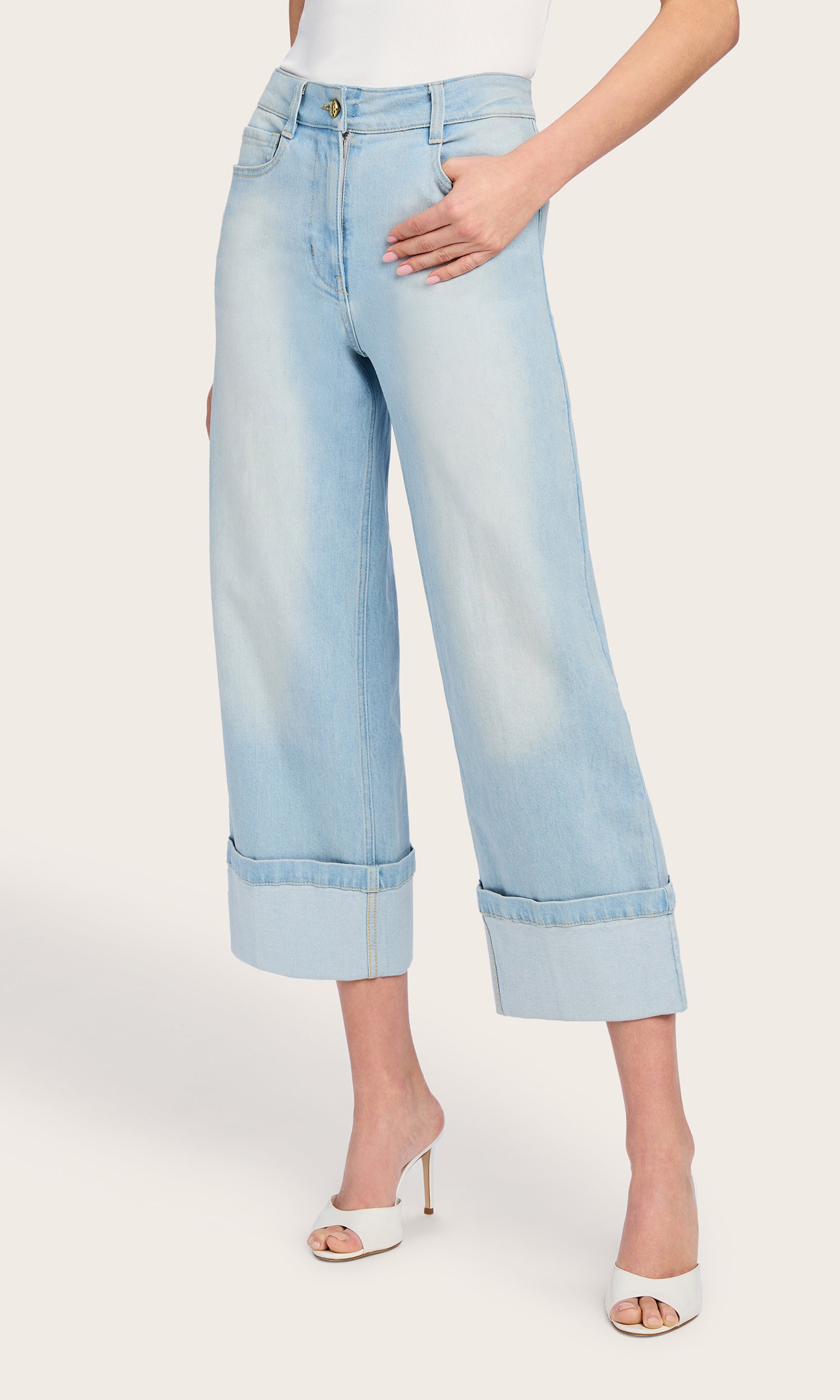 The model turns slightly to the side in the Eros Denim Pant, revealing the silhouette’s flow and the natural movement of the lightweight denim.