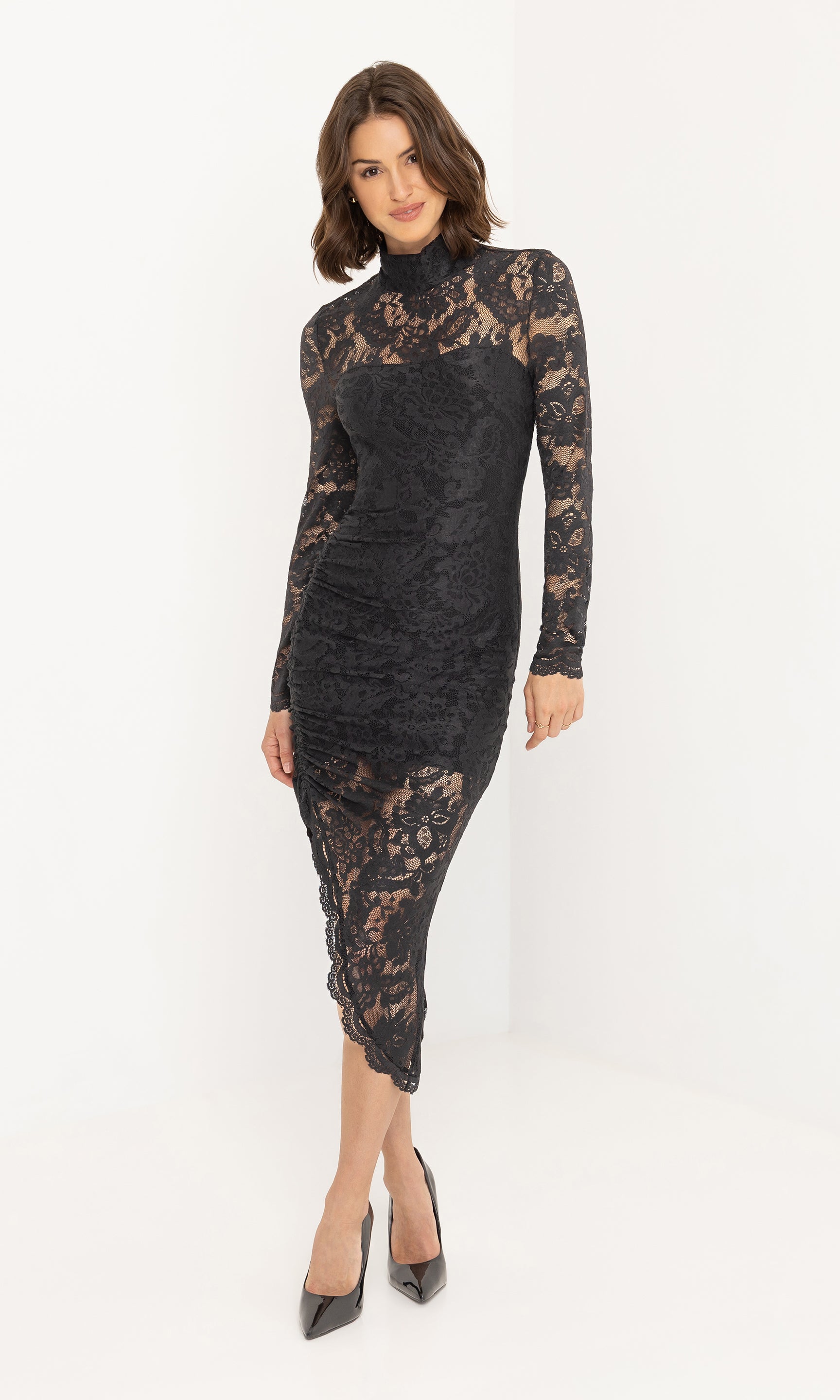 Full body front view of the iria lace dress styled with heels.